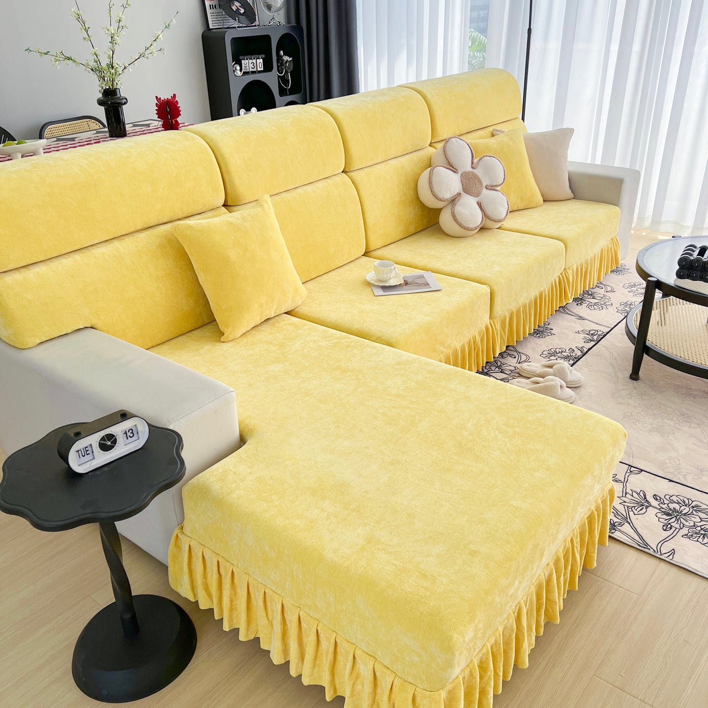 Universal Elastic Skirt Sofa Slipcover on a yellow sofa in modern living room, protecting furniture and enhancing decor.