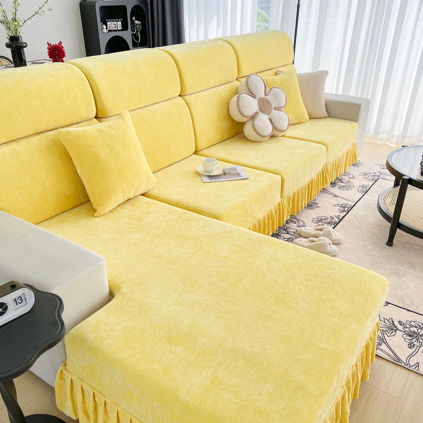 Universal Elastic Skirt Sofa Slipcover on a stylish yellow sofa in a modern living room, adding protection and a fresh look to furniture.