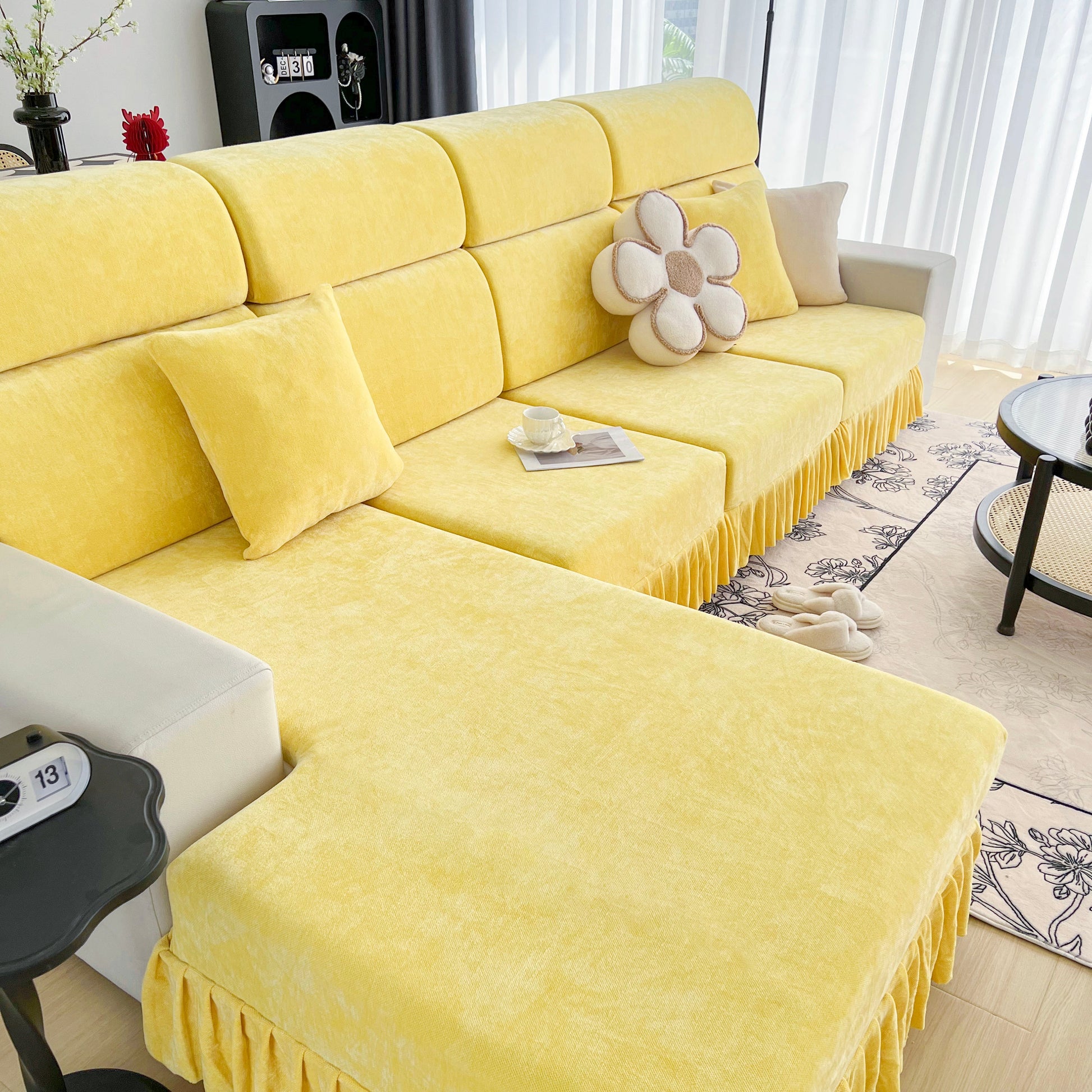 Universal Elastic Skirt Sofa Slipcover on a stylish yellow sofa in a modern living room, adding protection and a fresh look to furniture.