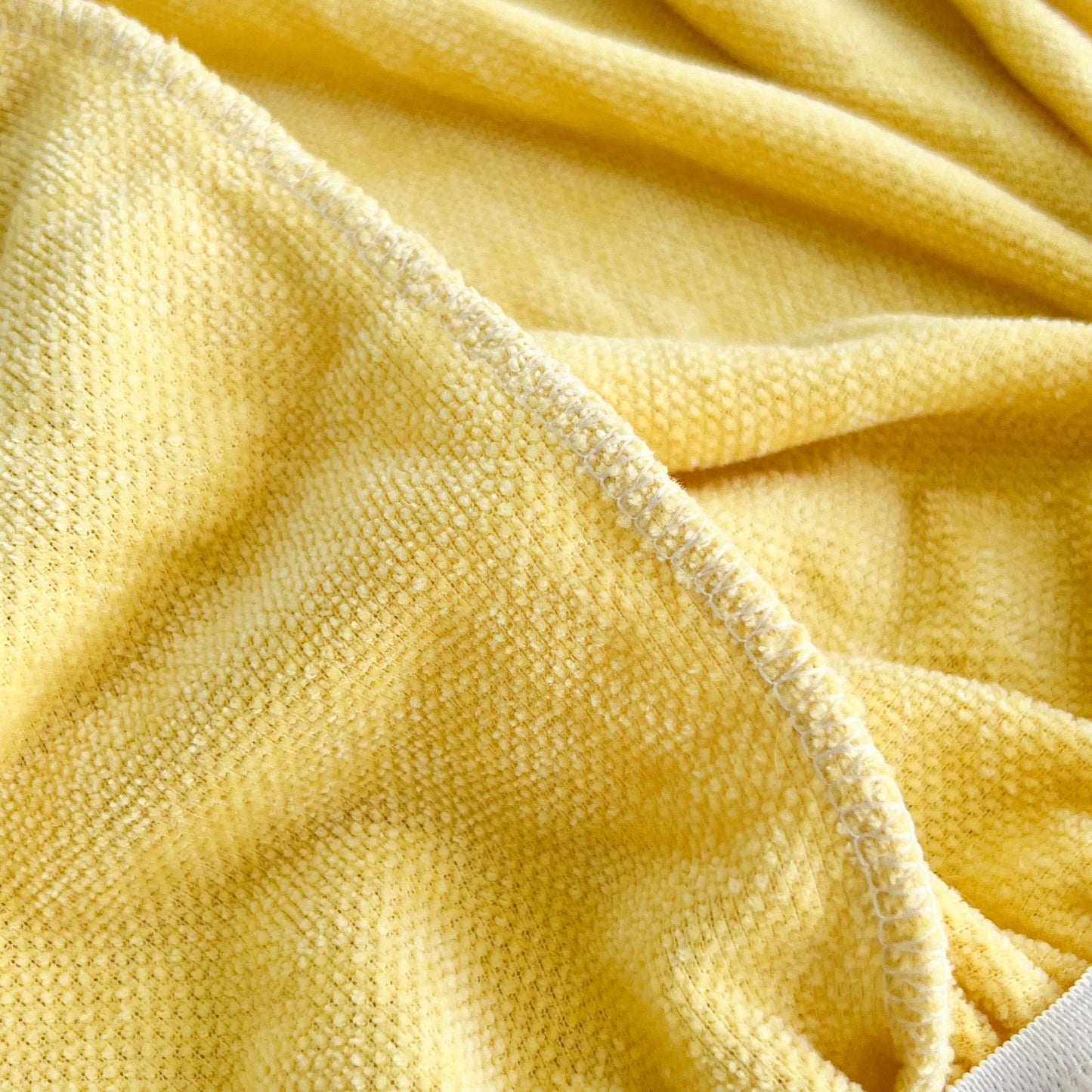 Close-up of yellow fabric texture for Universal Elastic Skirt Sofa Slipcover, Stretch Sofa Cushion Cover For Bedroom Office Living Room.