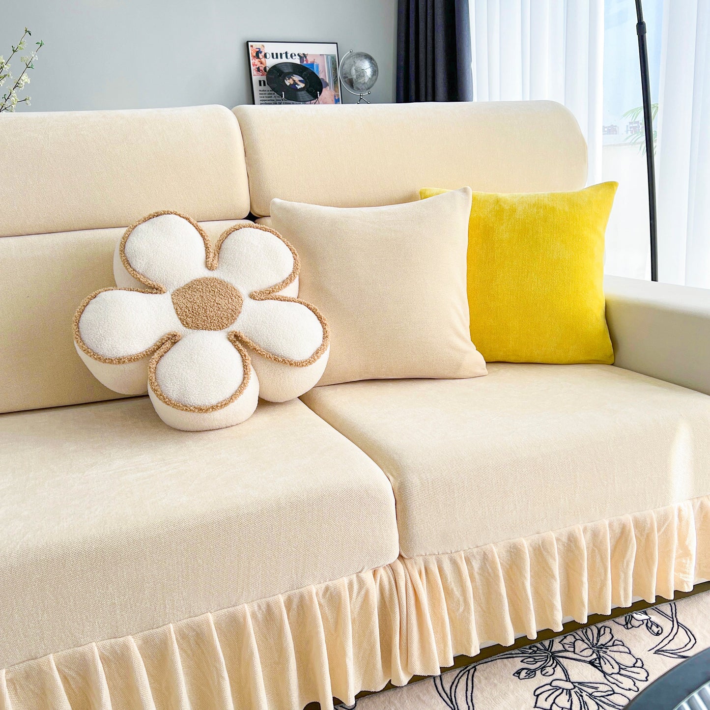 Universal Elastic Skirt Sofa Slipcover on a beige sofa with decorative pillows in a bright living room setting.