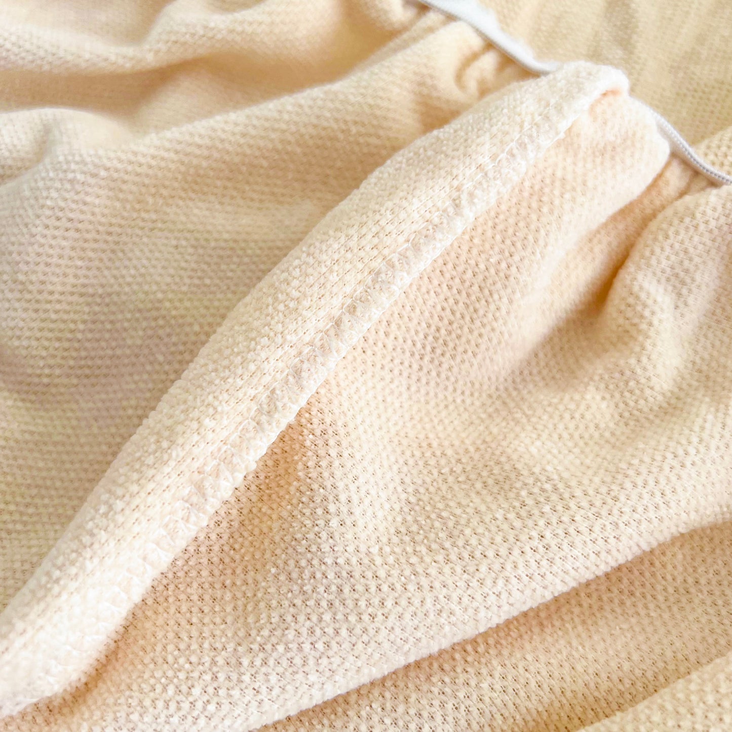 Close-up of Universal Elastic Skirt Sofa Slipcover fabric detail in beige, showcasing soft and durable Chenille material for living room or office.