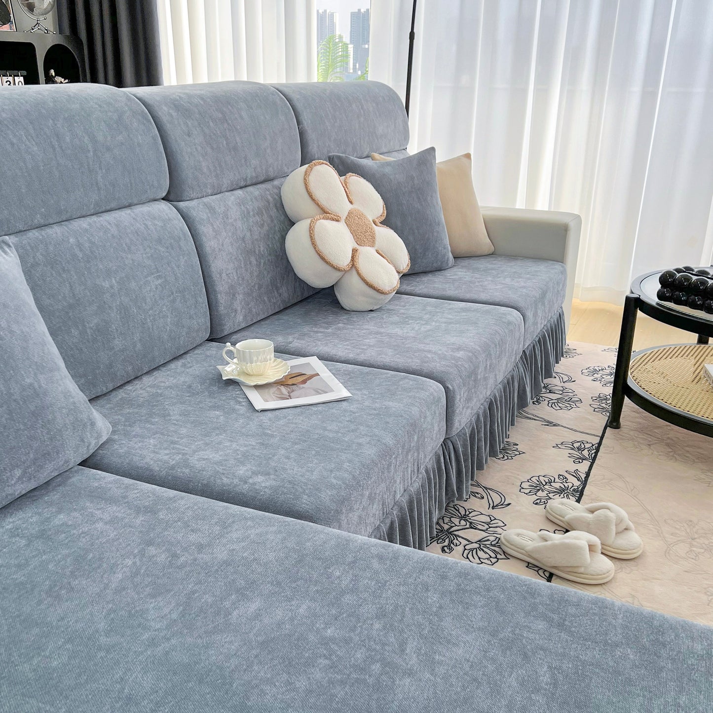 Universal Elastic Skirt Sofa Slipcover on a stylish living room sofa, showcasing a modern and cozy look with decorative pillows.