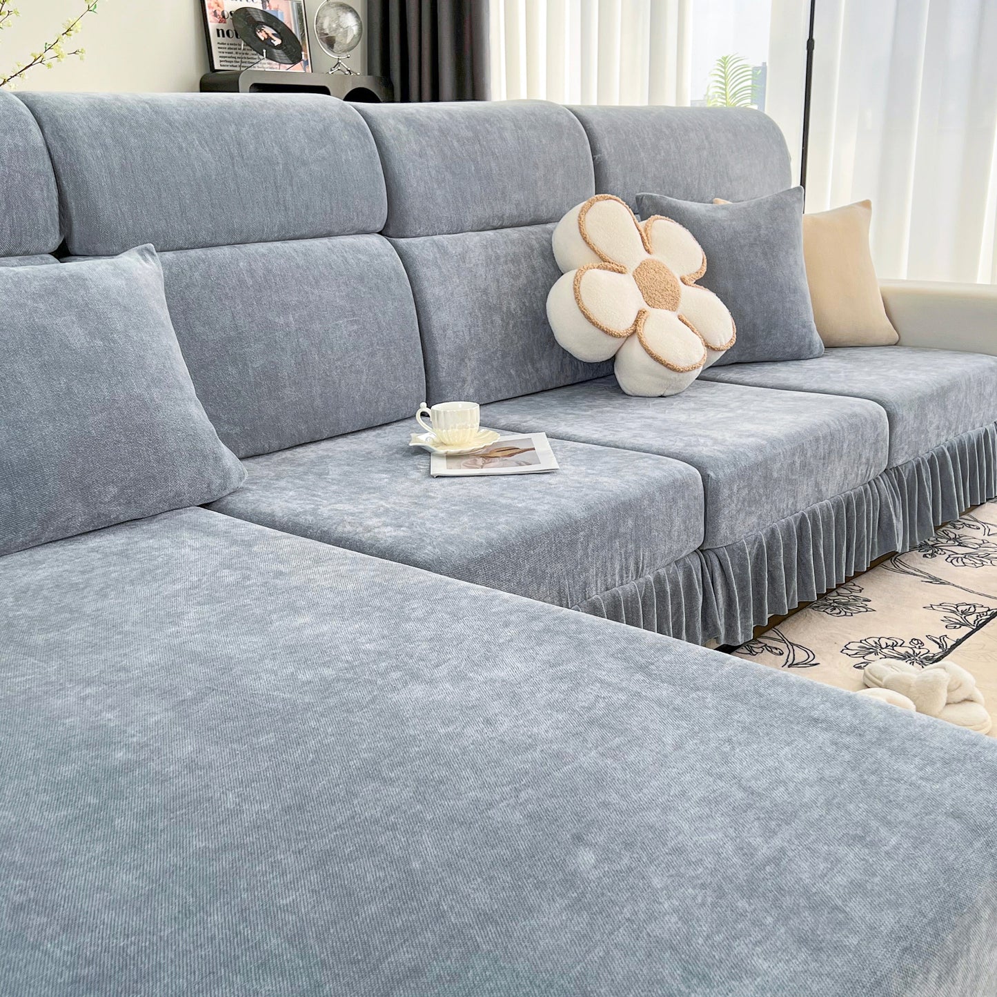 Universal Elastic Skirt Sofa Slipcover on modern living room sofa, featuring soft Chenille fabric for style and protection.
