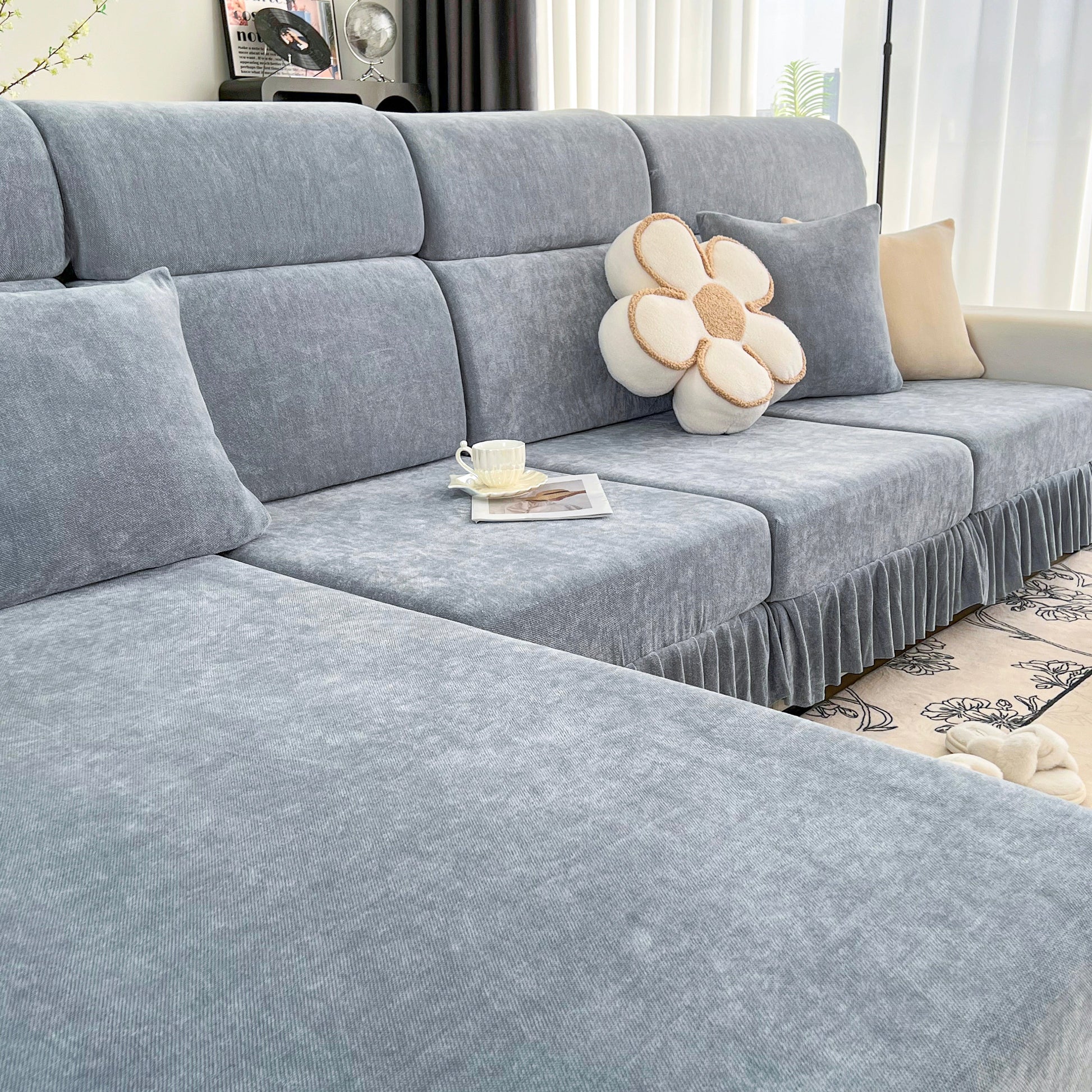 Universal Elastic Skirt Sofa Slipcover on modern living room sofa, featuring soft Chenille fabric for style and protection.