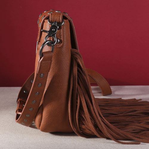 Side view of Montana West Fringe Mariposa Concho Collection Crossbody showcasing brown simulated leather with fringe detailing.