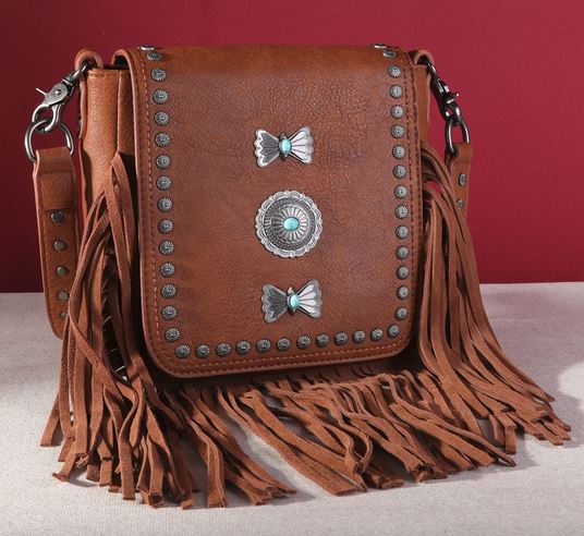 Montana West Fringe Mariposa Concho Collection Crossbody with Native American influenced design and silver conchos on red background