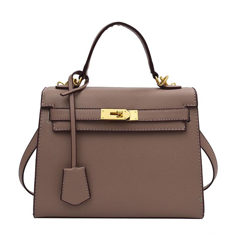 Luxury Cowgirl Kelly Purse – Trendy, High-Fashion Leather Handbag with Adjustable Strap in taupe with buckle design.