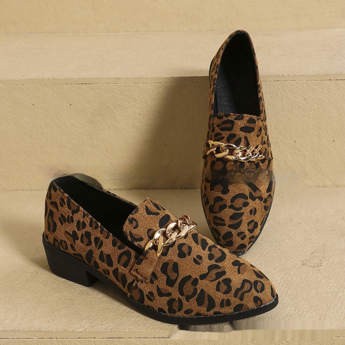 Women’s Leopard Print Pumps with bow accent and chain detail, chic and versatile, perfect for bold fashion statement.