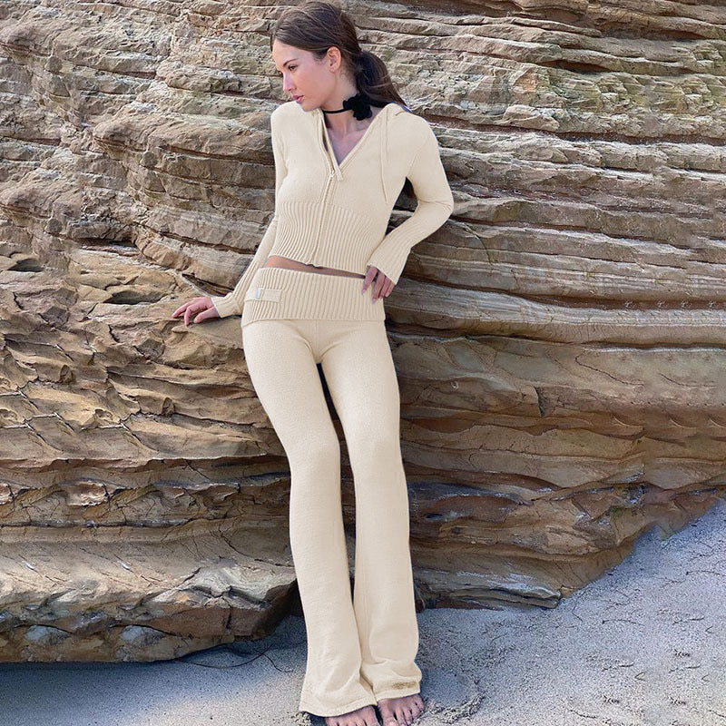 Woman wearing Women’s Knitted Hooded Two-Piece Set – Cardigan & High-Waisted Pants Suit by the beach