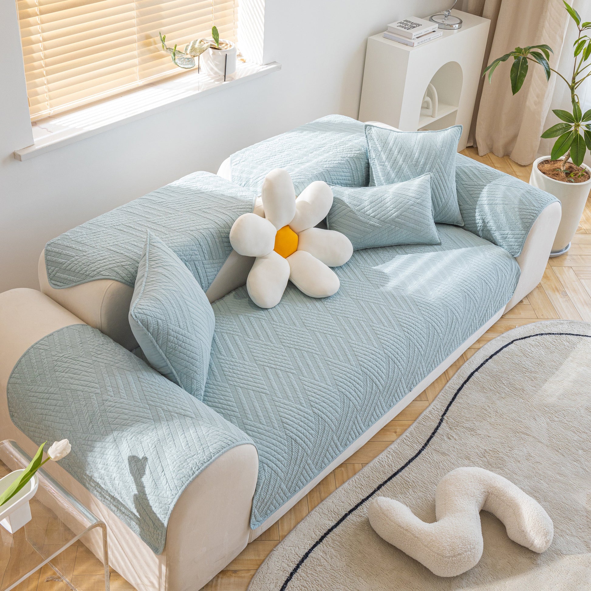 Quilted Geometric Cotton Sofa Cover, Non-Slip & Thick Padded Furniture Covers with diagonal stitching on a modern sofa setup