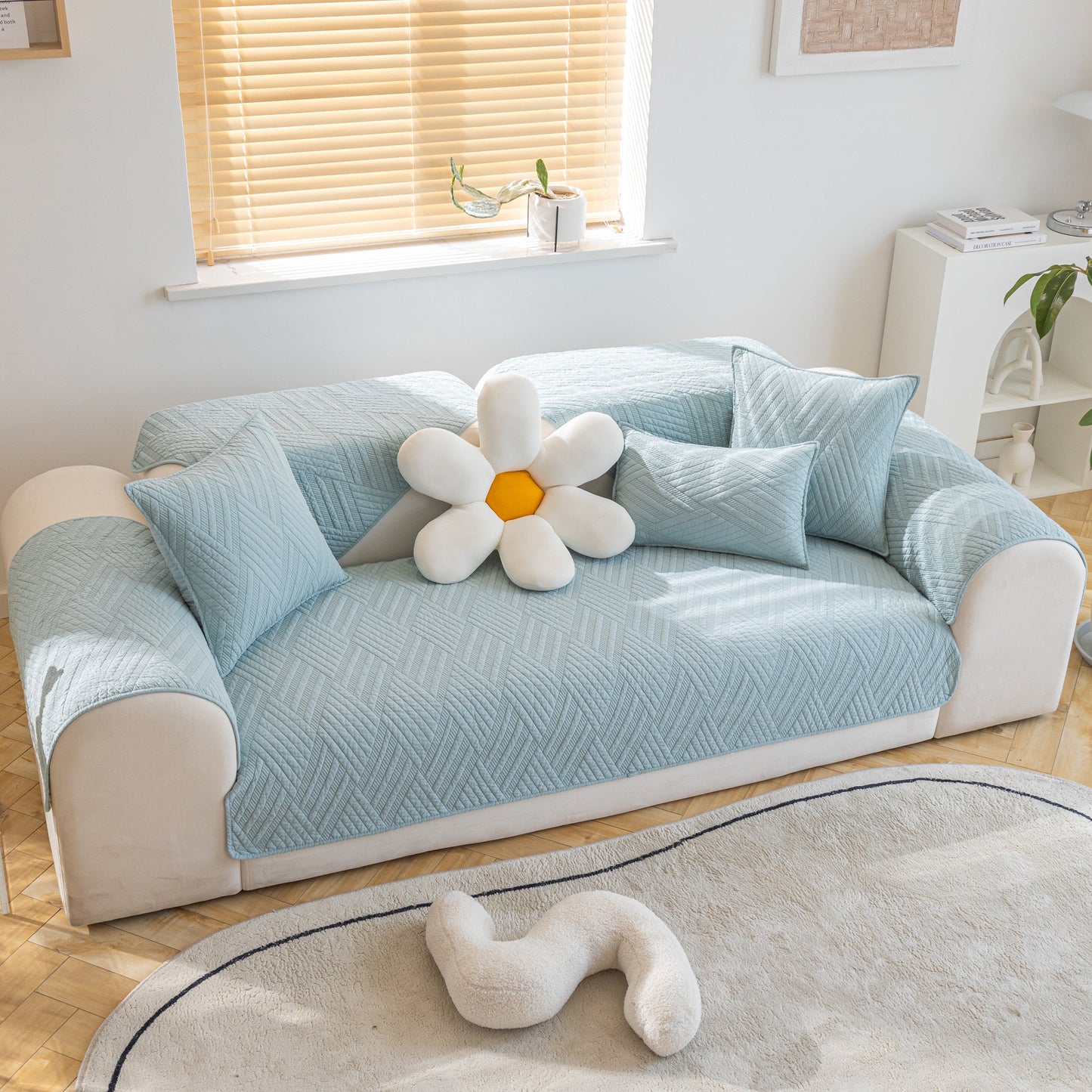 Stylish living room with Quilted Geometric Cotton Sofa Cover, Non-Slip & Thick Padded Furniture Covers in blue.