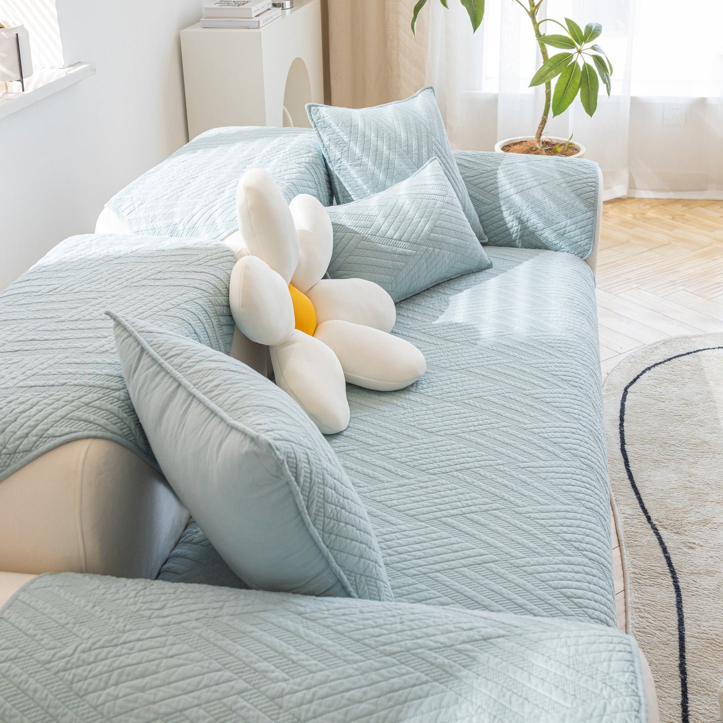 Quilted Geometric Cotton Sofa Cover, Non-Slip & Thick Padded Furniture Covers in light blue with quilted geometric pattern.