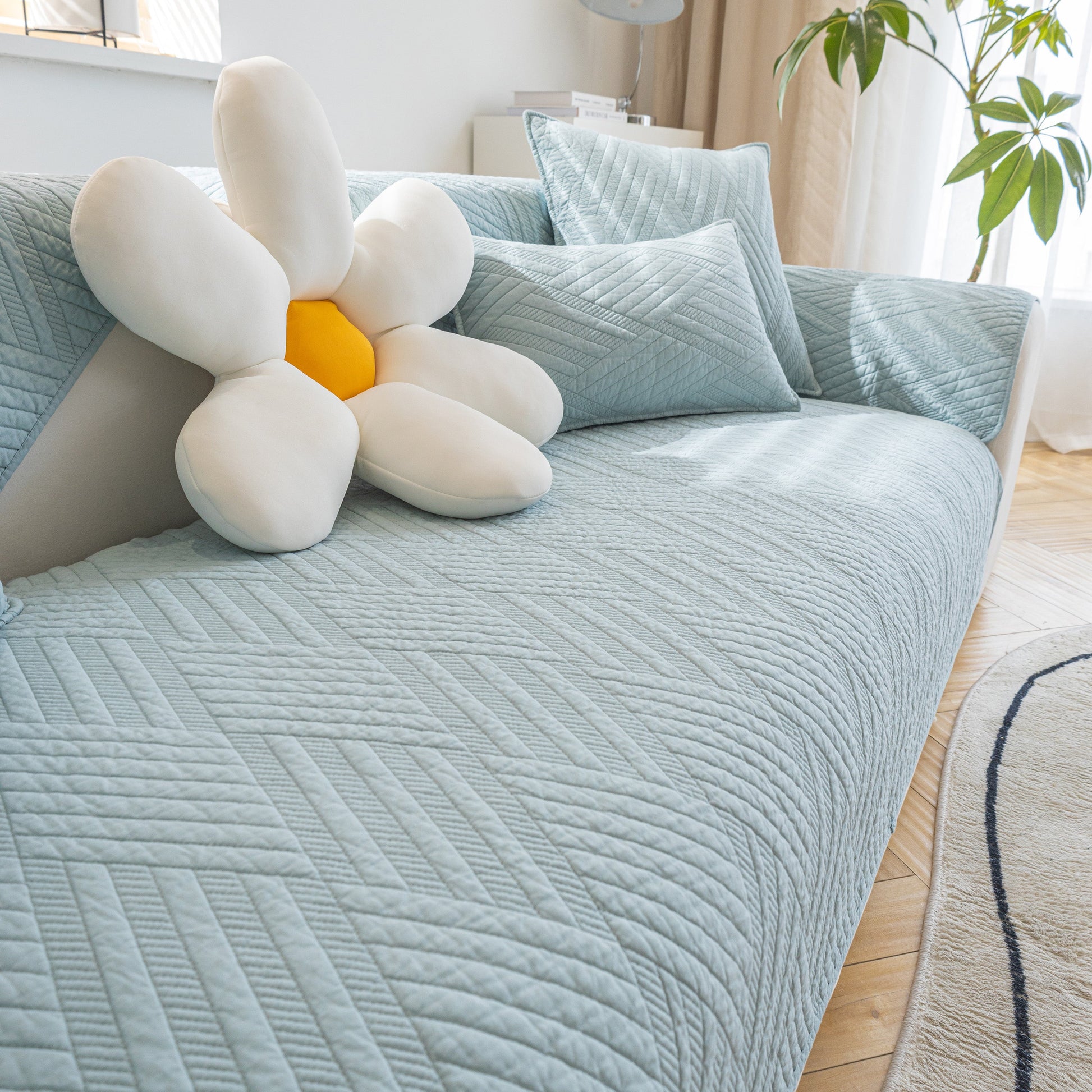 Quilted Geometric Cotton Sofa Cover, Non-Slip & Thick Padded Furniture Covers on a sofa with decorative pillows.