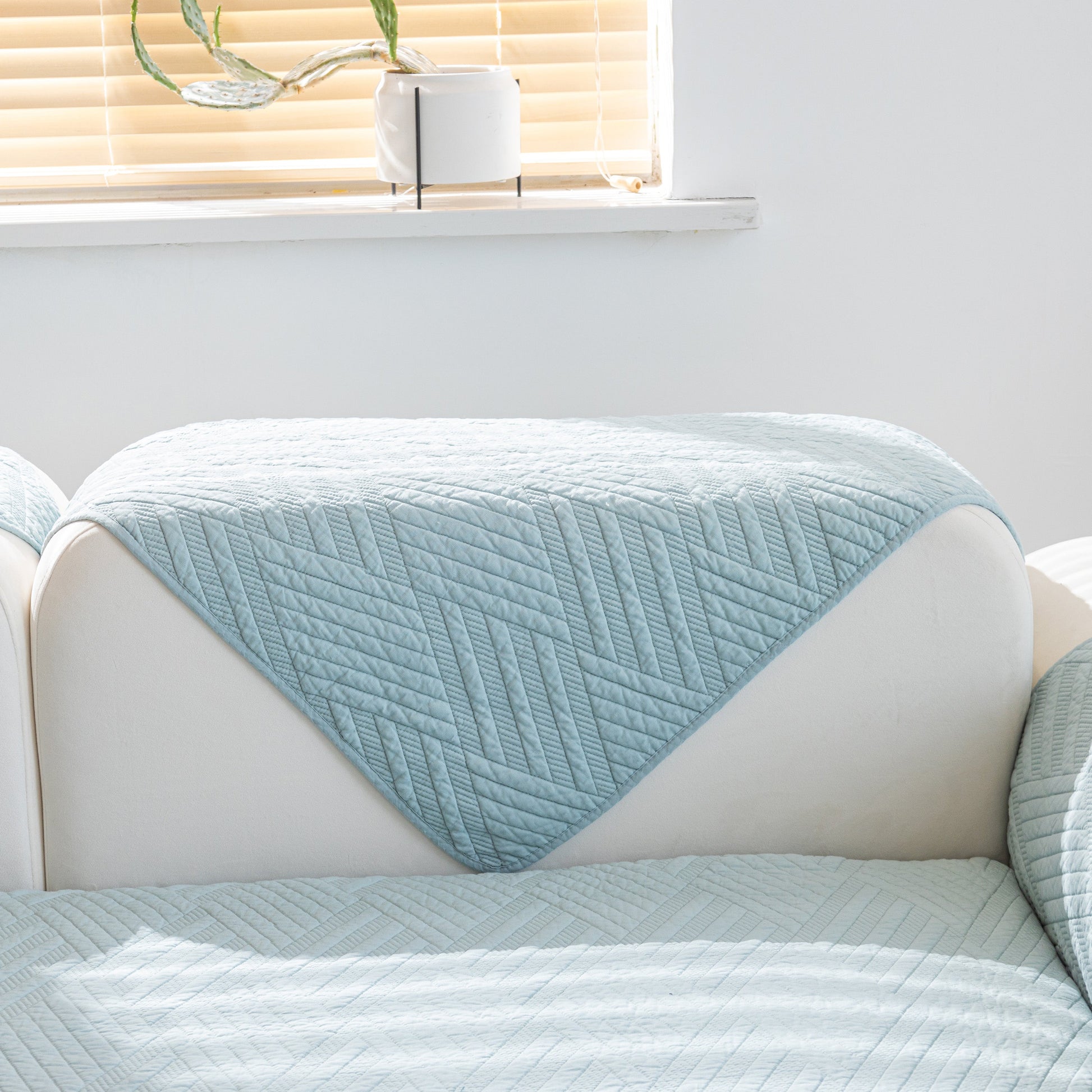 Quilted Geometric Cotton Sofa Cover, Non-Slip & Thick Padded Furniture Covers displayed on a white sofa.