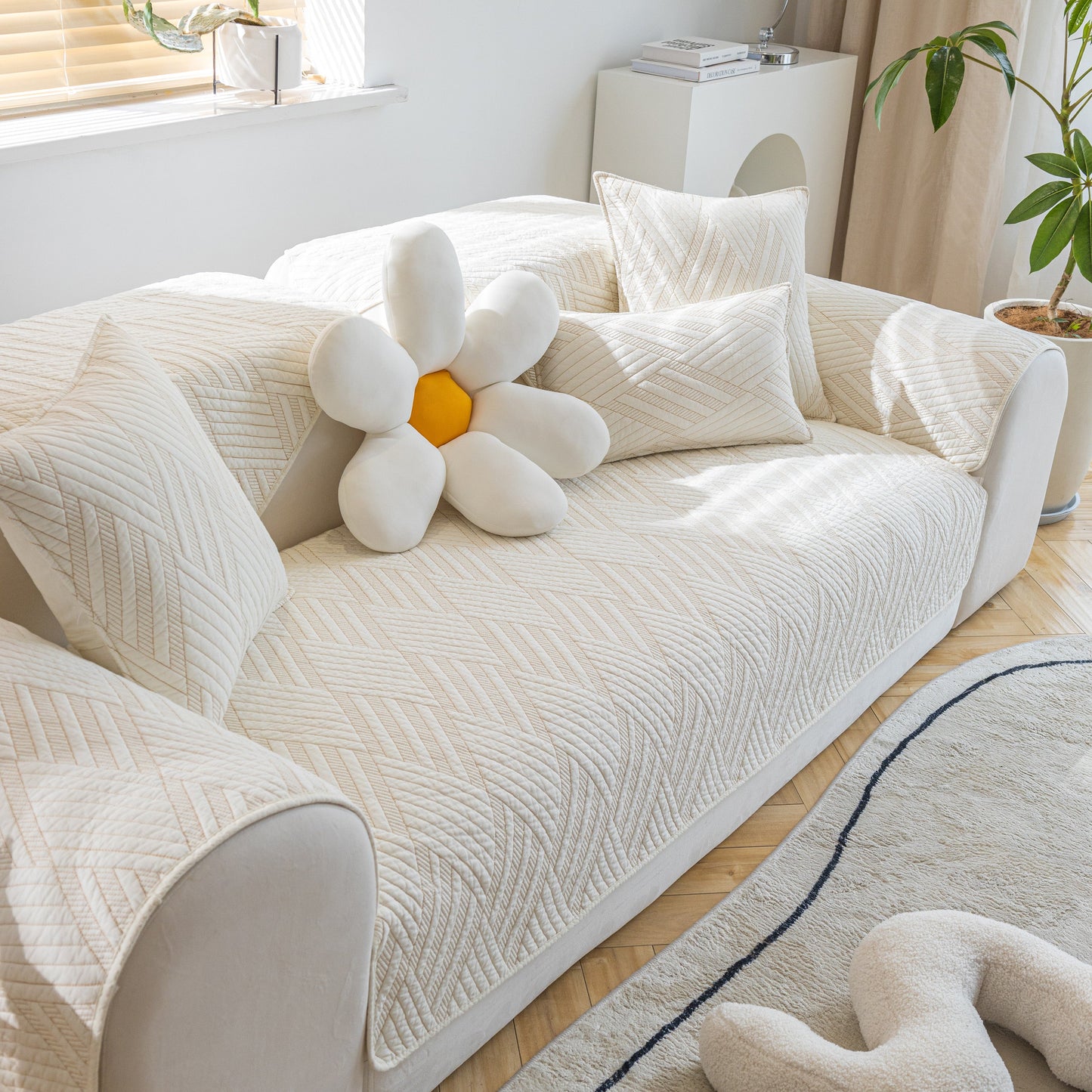 Quilted Geometric Cotton Sofa Cover, Non-Slip & Thick Padded Furniture Covers on a cream couch with decorative pillows.