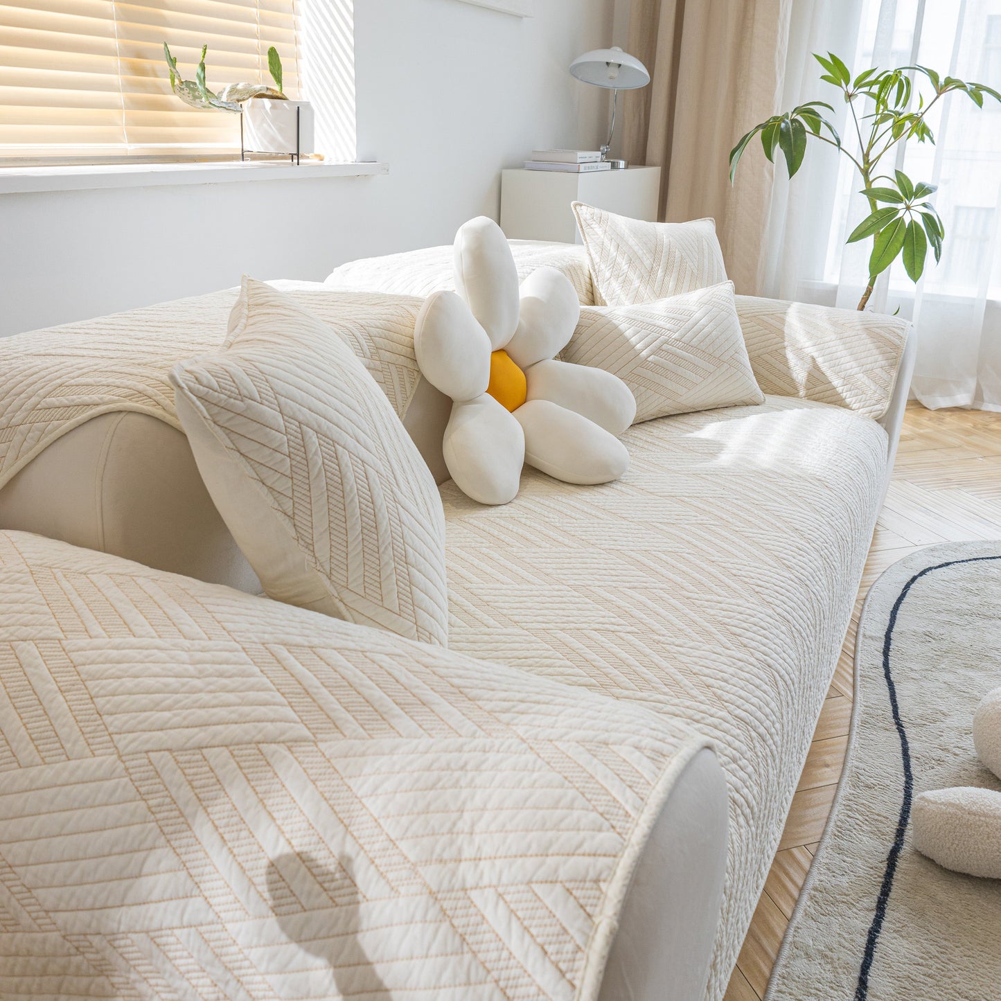 Quilted Geometric Cotton Sofa Cover, Non-Slip & Thick Padded Furniture Covers on contemporary sofa with pillows in sunlit room.