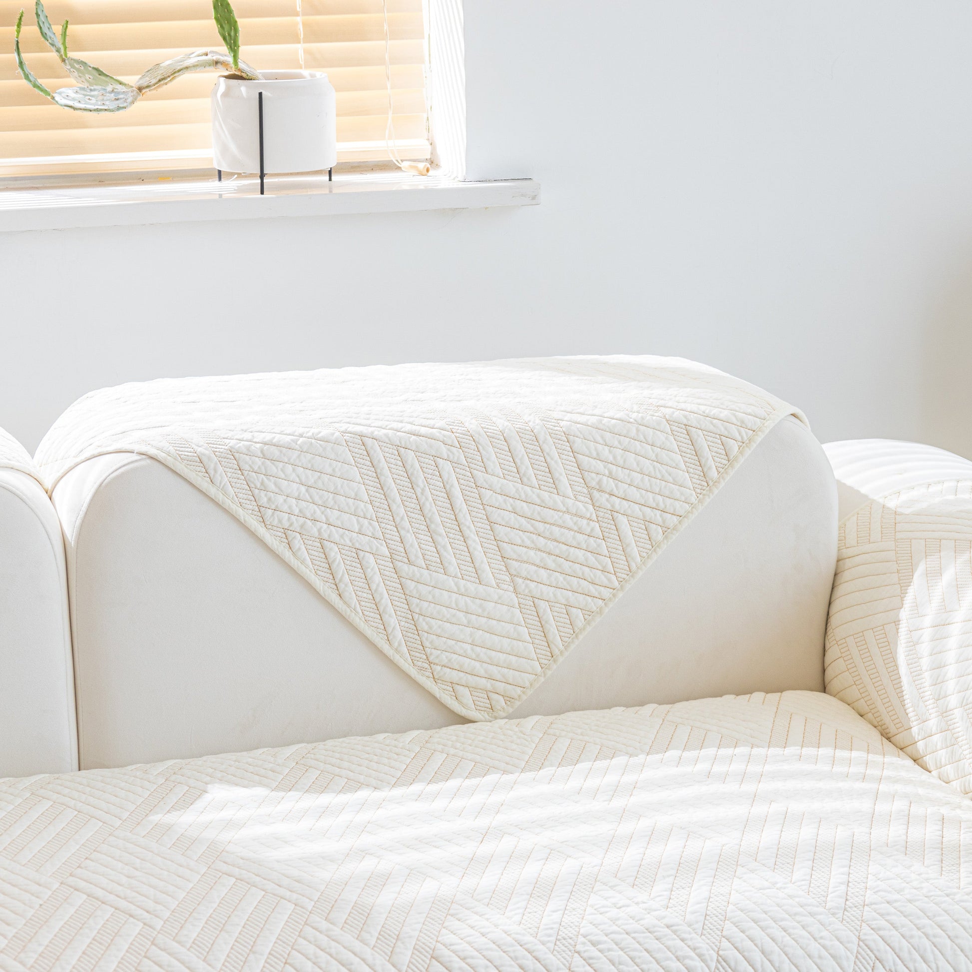 Quilted Geometric Cotton Sofa Cover, Non-Slip & Thick Padded Furniture Covers on white sofa showing texture and pattern.