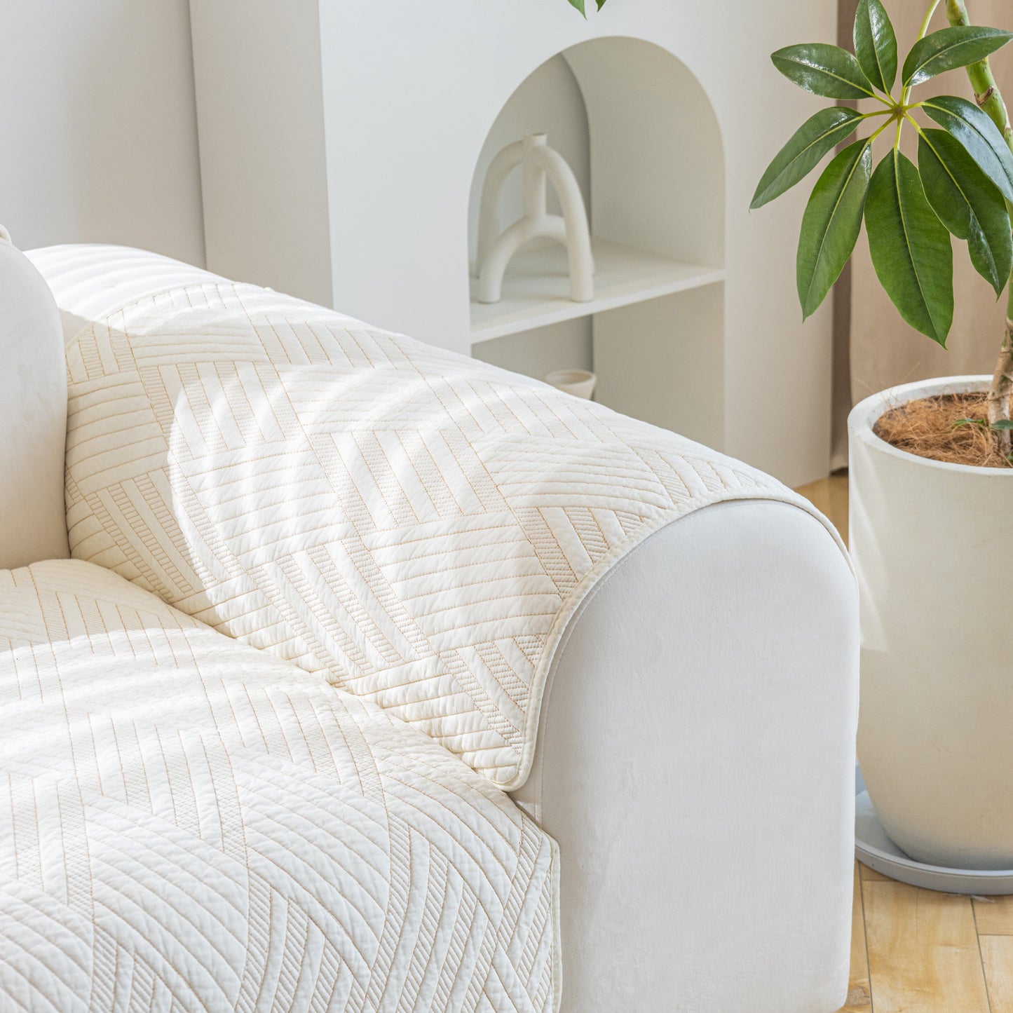 Quilted Geometric Cotton Sofa Cover, Non-Slip & Thick Padded Furniture Covers on a white sofa with elegant texture in a modern room