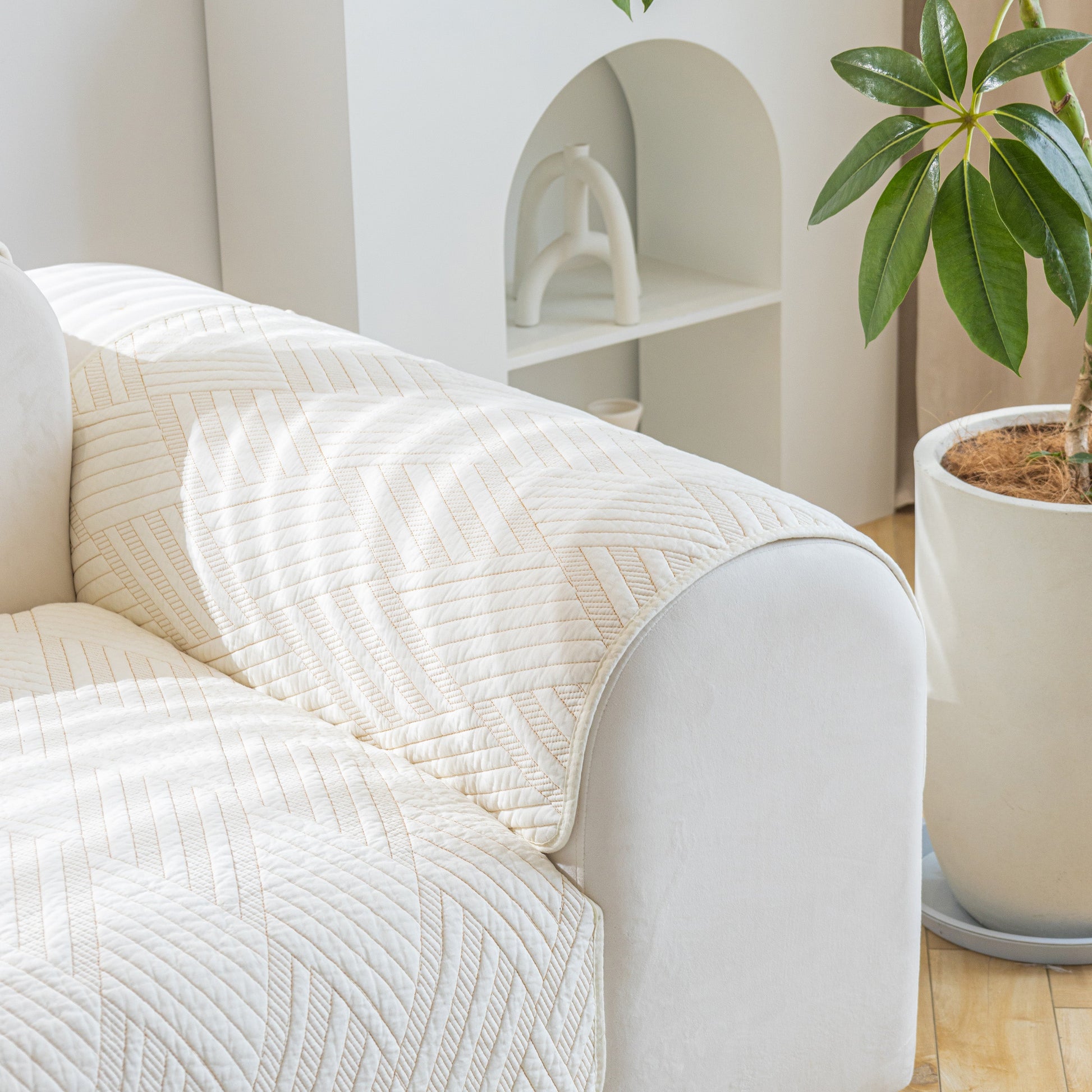 Quilted Geometric Cotton Sofa Cover, Non-Slip & Thick Padded Furniture Covers on a white sofa with elegant texture in a modern room