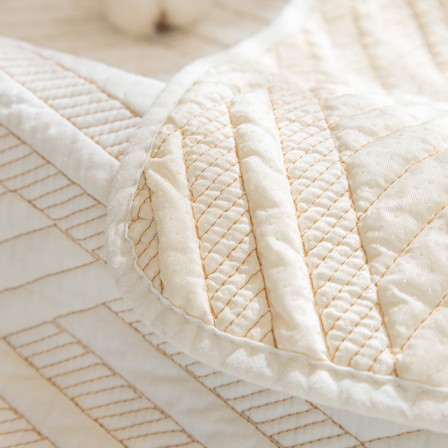 Close-up of Quilted Geometric Cotton Sofa Cover, Non-Slip & Thick Padded Furniture Covers with diagonal stitching pattern.