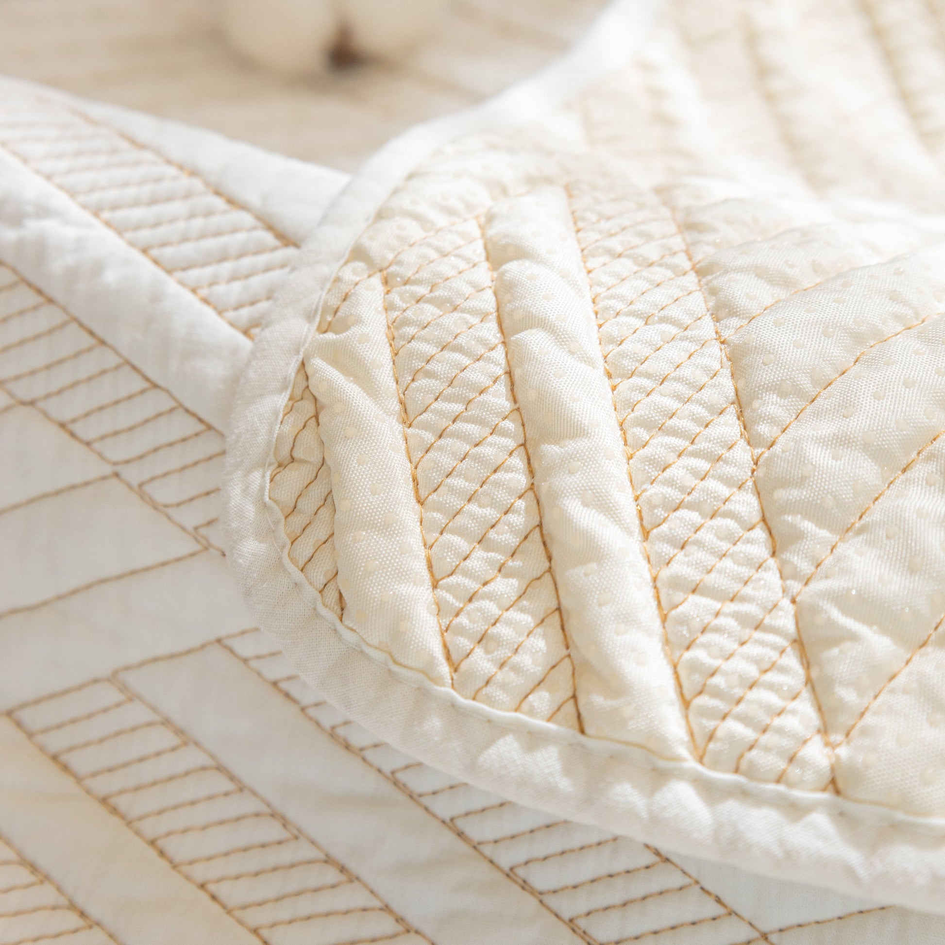 Close-up of Quilted Geometric Cotton Sofa Cover, Non-Slip & Thick Padded Furniture Covers with diagonal stitching pattern.
