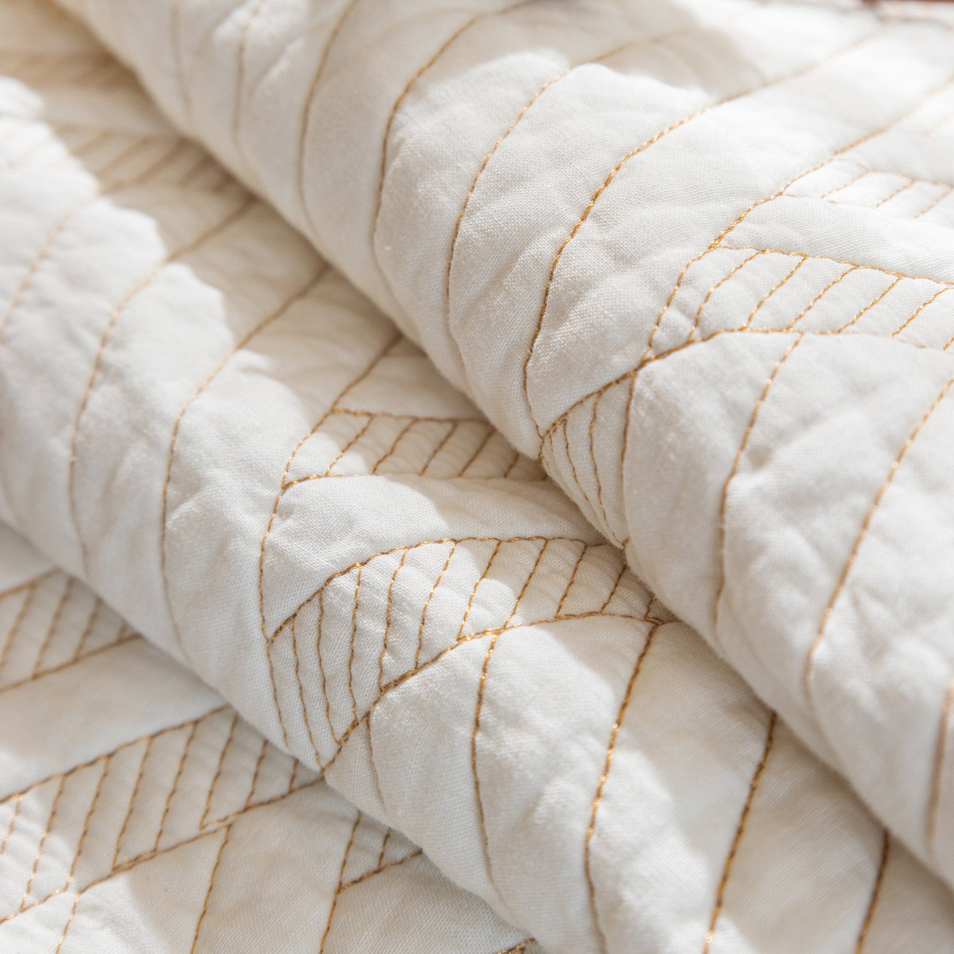 Close-up of Quilted Geometric Cotton Sofa Cover, Non-Slip & Thick Padded Furniture Covers with textured diagonal pattern.