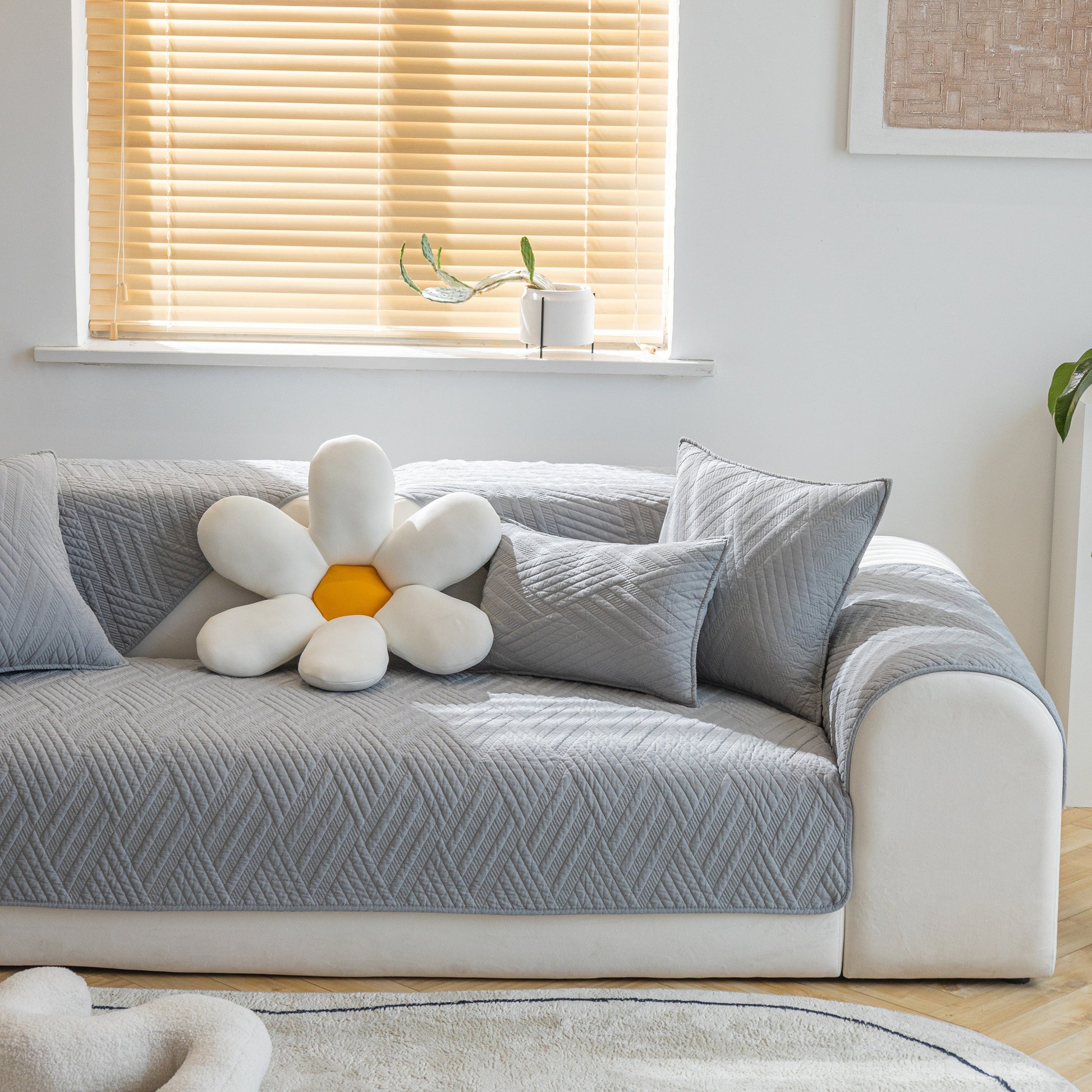 Quilted Geometric Cotton Sofa Cover, Non-Slip & Thick Padded Furniture Covers on a grey couch with decorative cushions.