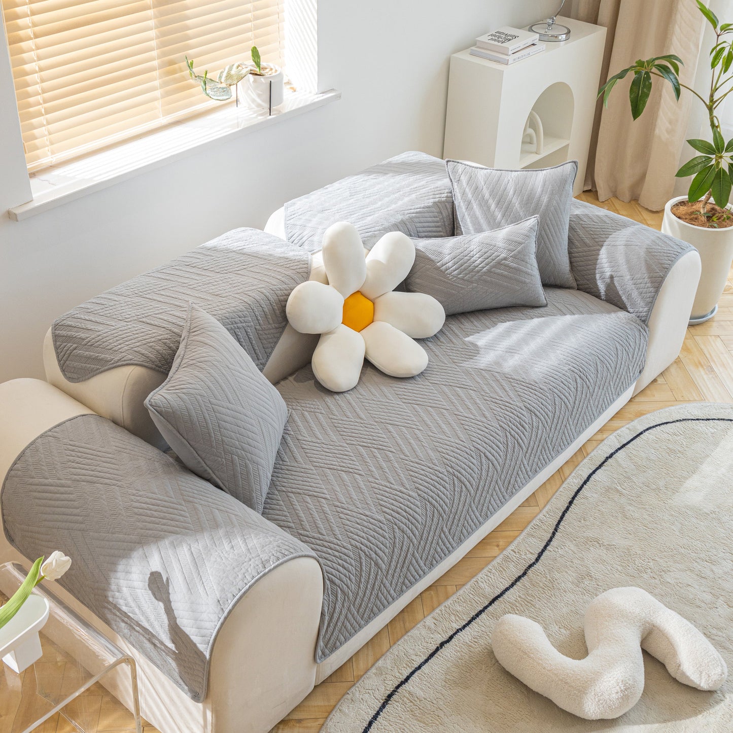 Quilted Geometric Cotton Sofa Cover, Non-Slip & Thick Padded Furniture Covers on modern sofa with decorative pillows.