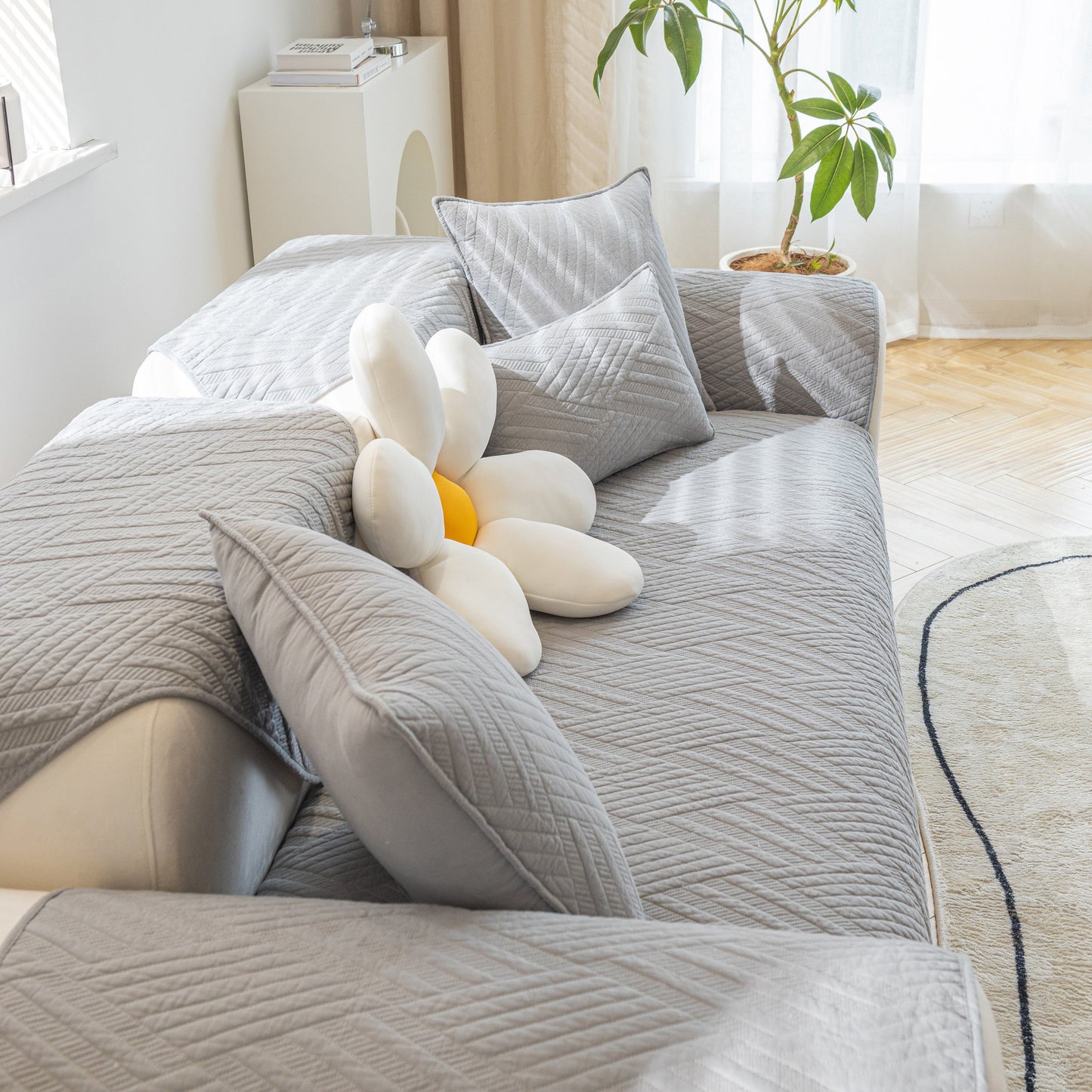 Quilted Geometric Cotton Sofa Cover, Non-Slip & Thick Padded Furniture Covers on a modern sofa with decorative pillows.
