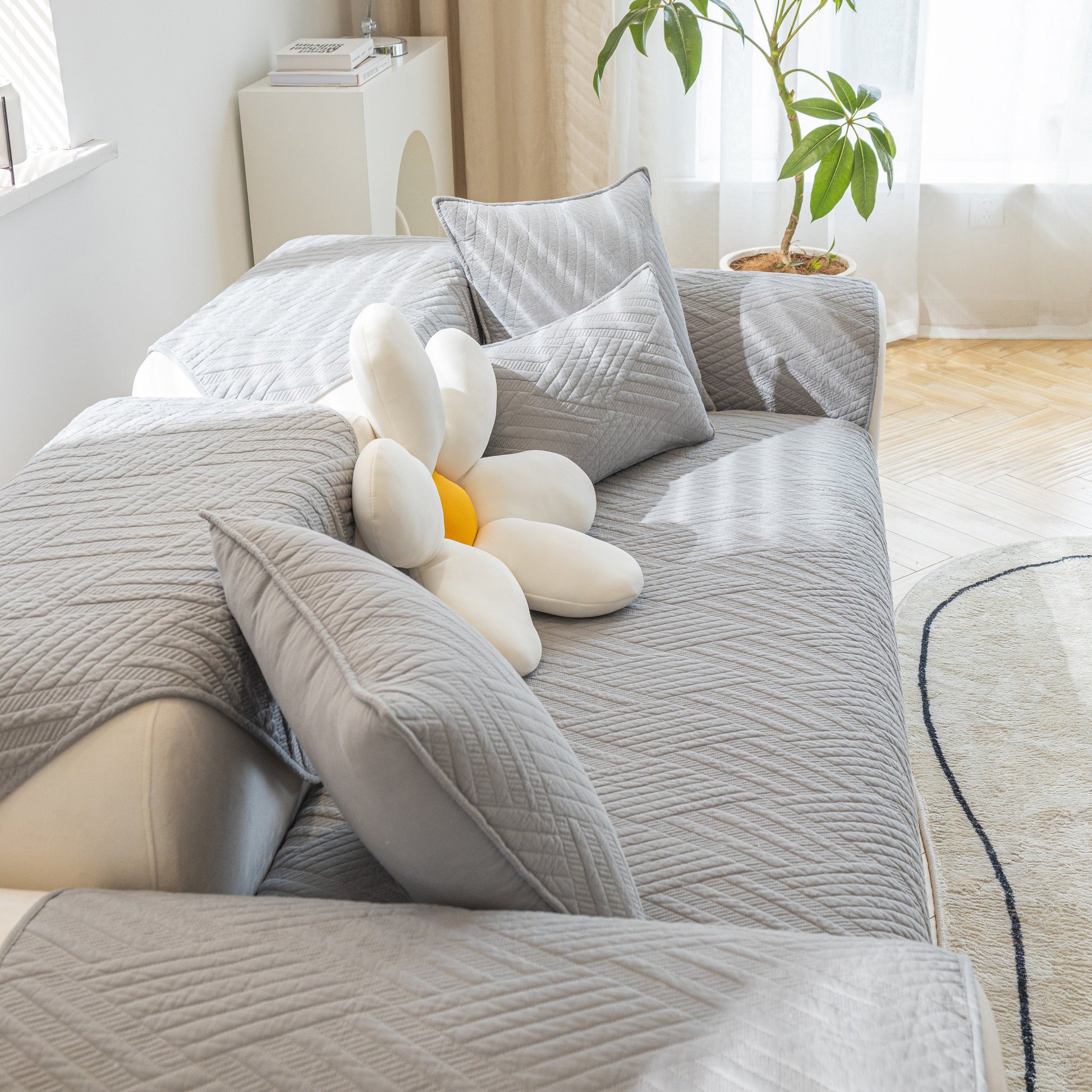 Quilted Geometric Cotton Sofa Cover, Non-Slip & Thick Padded Furniture Covers on a modern sofa with decorative pillows.