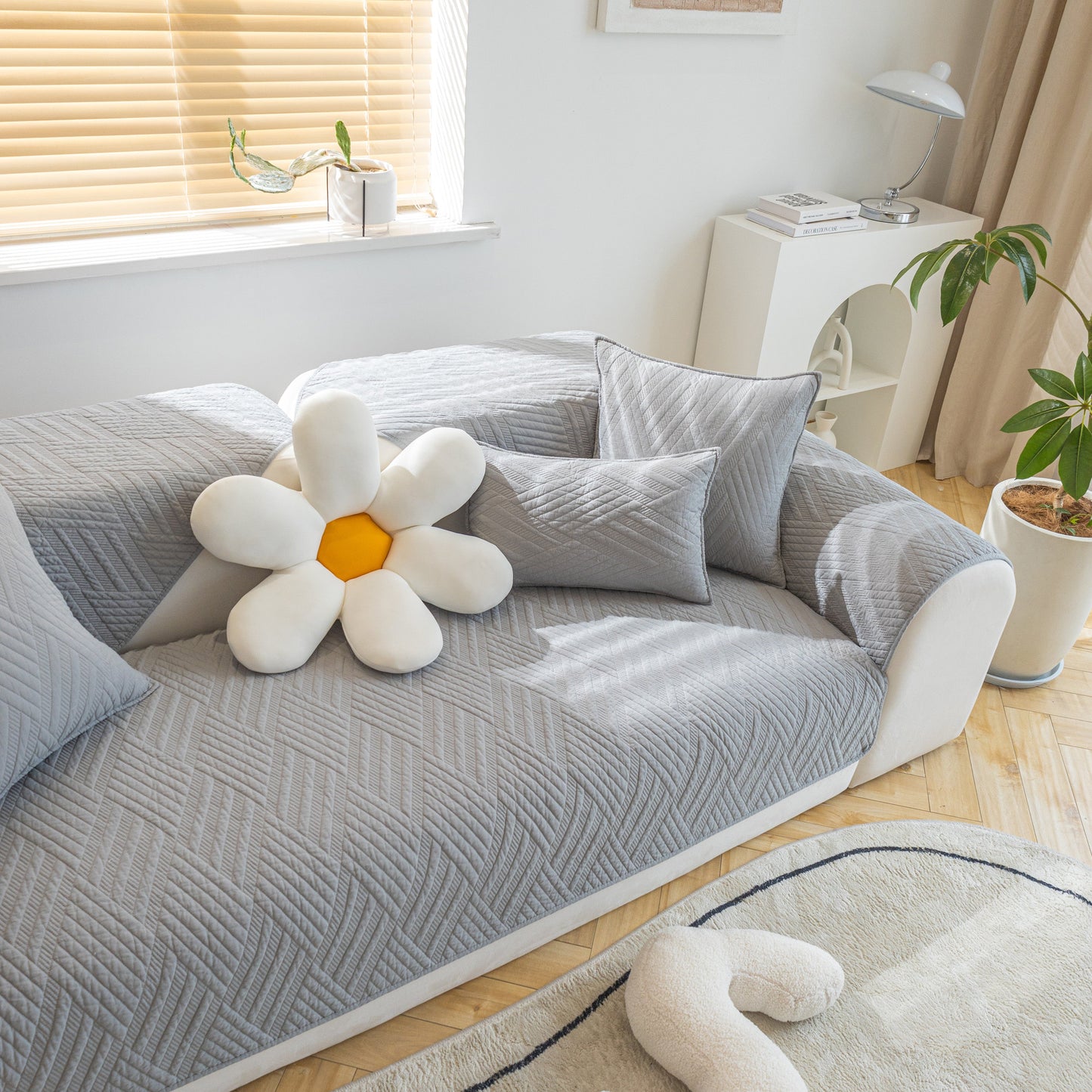 Quilted Geometric Cotton Sofa Cover, Non-Slip & Thick Padded Furniture Covers on a modern sofa setting with decorative pillows.