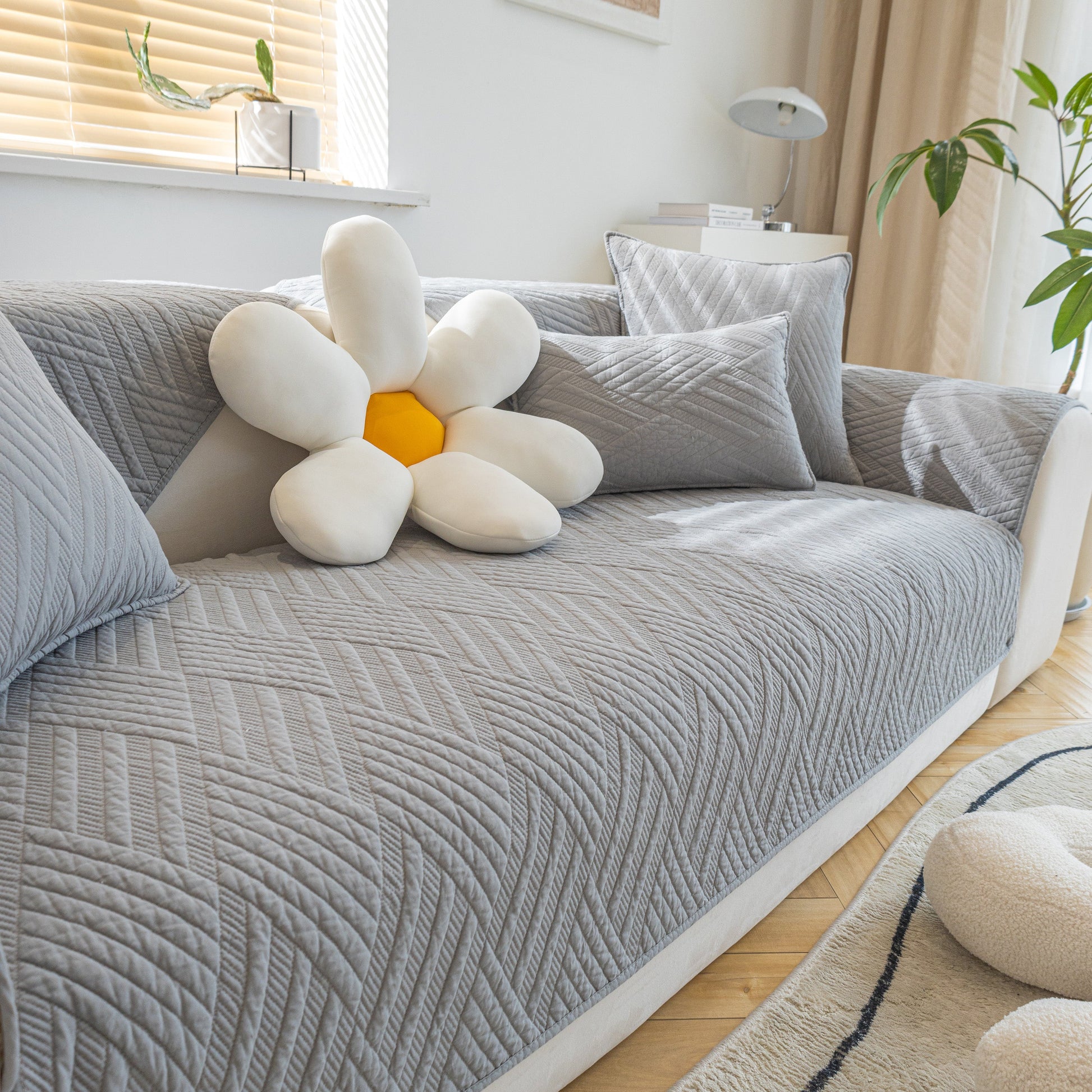 Quilted Geometric Cotton Sofa Cover, Non-Slip & Thick Padded Furniture Covers on a couch with geometric pattern.