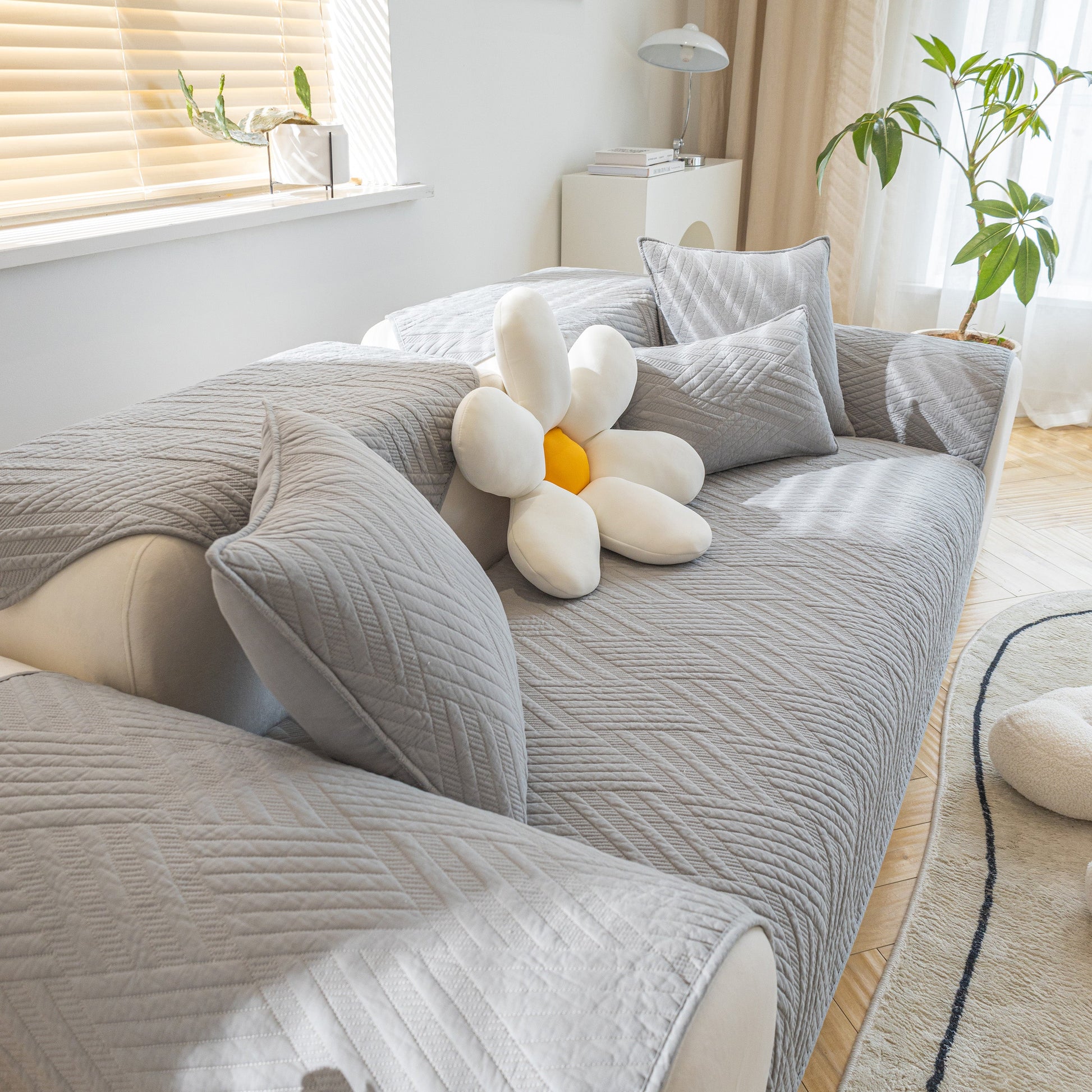 Quilted Geometric Cotton Sofa Cover, Non-Slip & Thick Padded Furniture Covers in a living room setting with cushions.