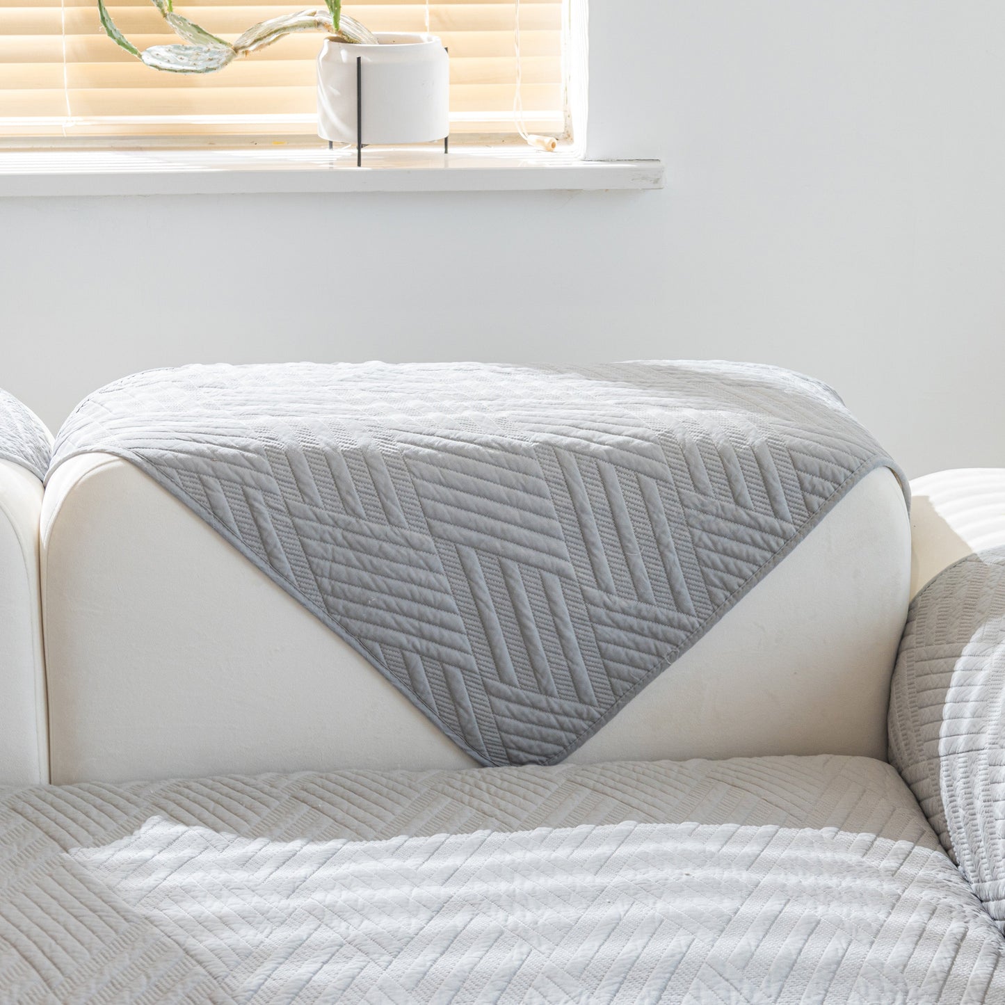 Quilted Geometric Cotton Sofa Cover, Non-Slip & Thick Padded Furniture Covers shown on a white sofa