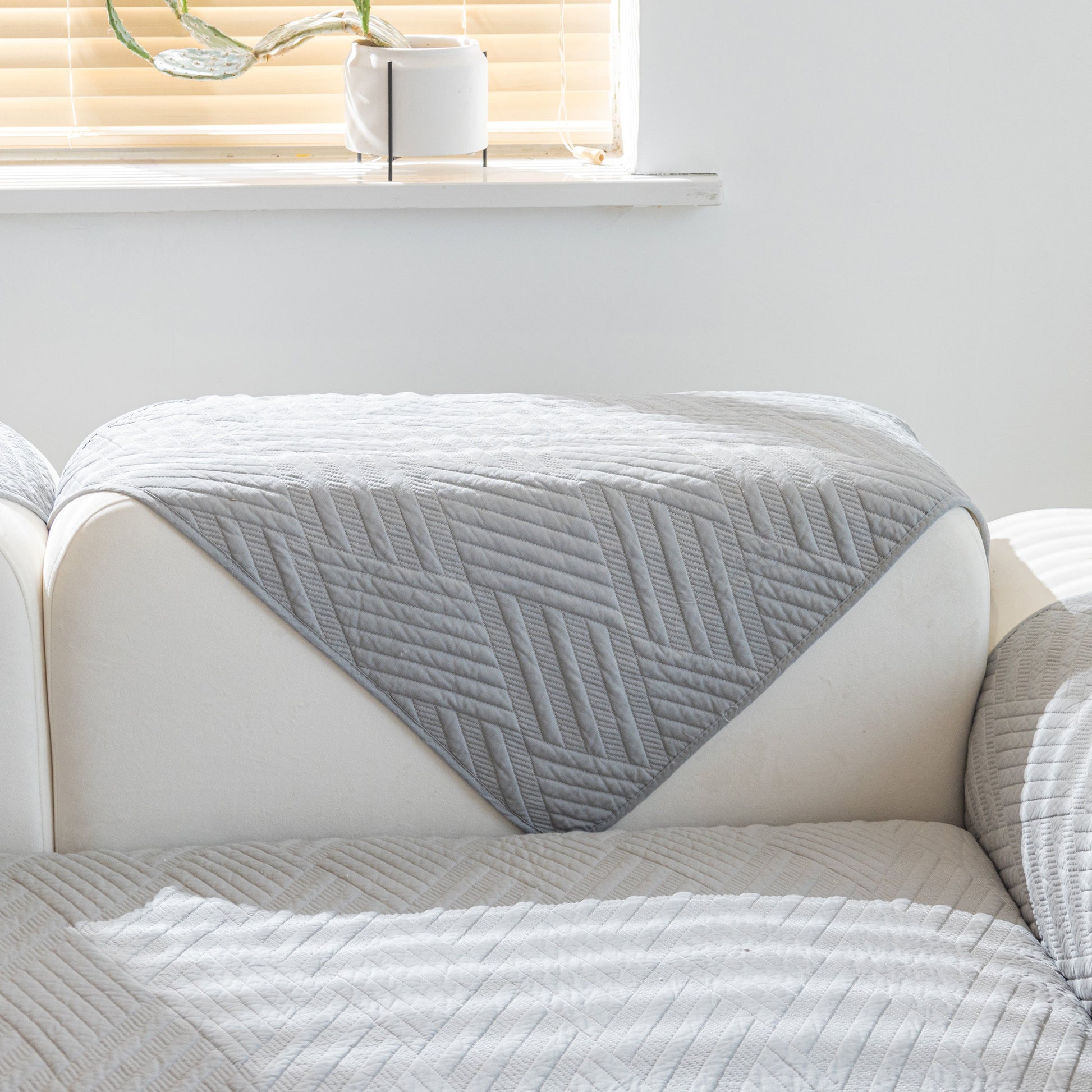 Quilted Geometric Cotton Sofa Cover, Non-Slip & Thick Padded Furniture Covers shown on a white sofa