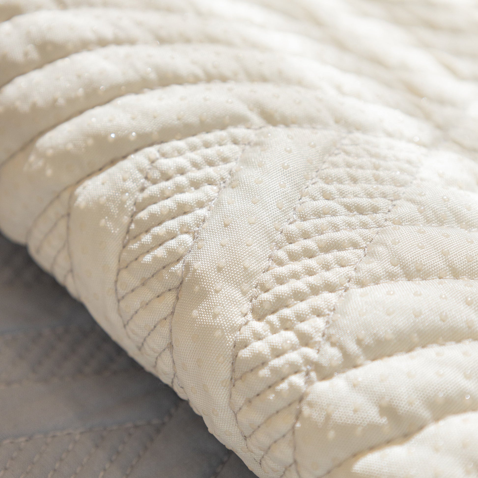 Close-up of Quilted Geometric Cotton Sofa Cover, Non-Slip & Thick Padded Furniture Covers showing textured pattern.