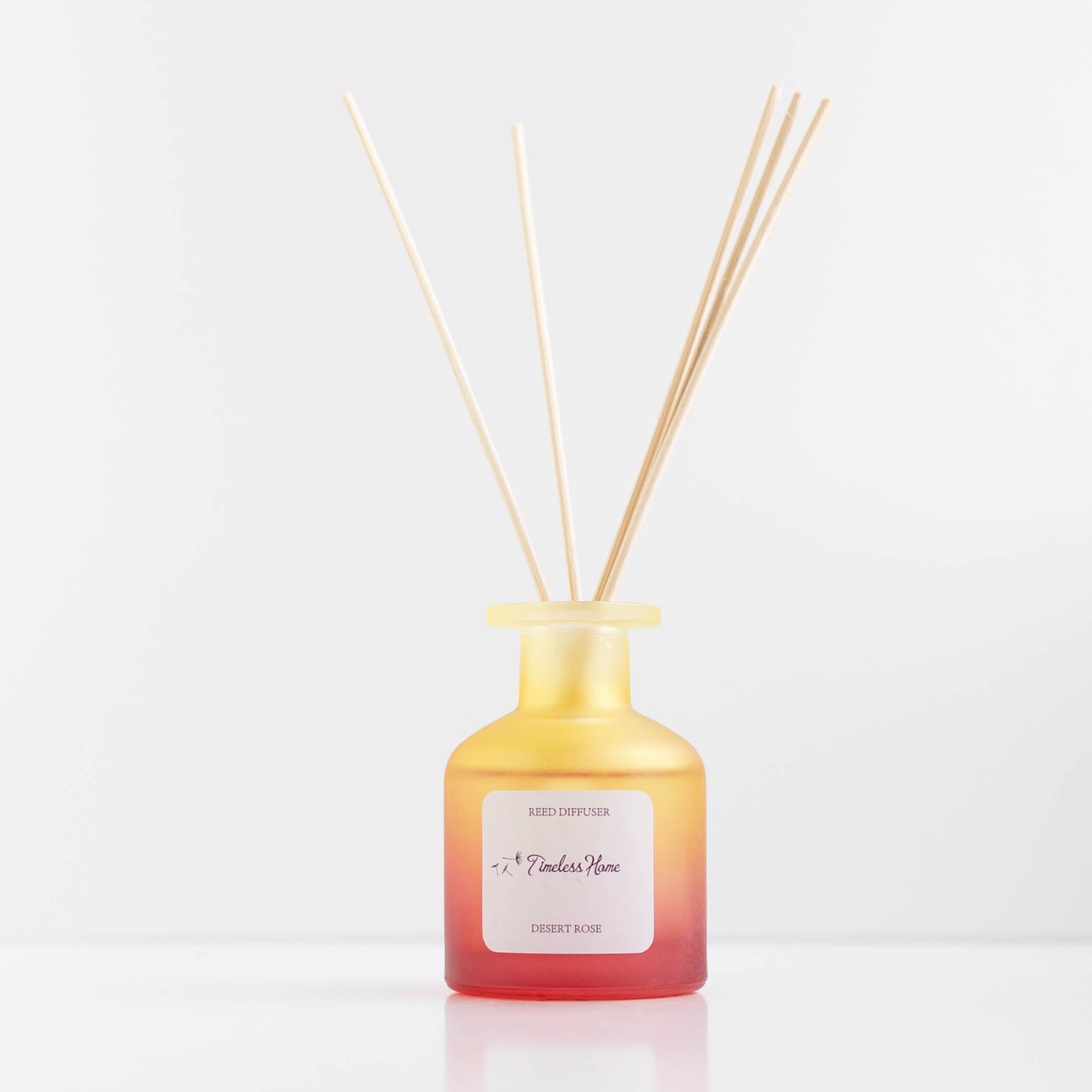 Reed Diffuser - Desert Rose in frosted glass with natural reed sticks releasing luxurious rose fragrance.