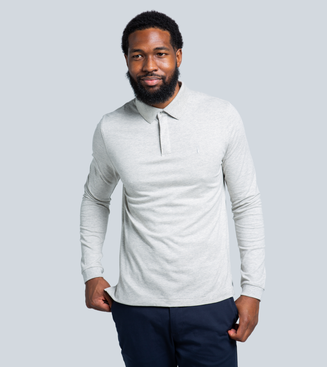 Man wearing a gray Long Sleeve Perfect Polo with unique features like StaySharp™ Collar and hidden microfiber cloth.