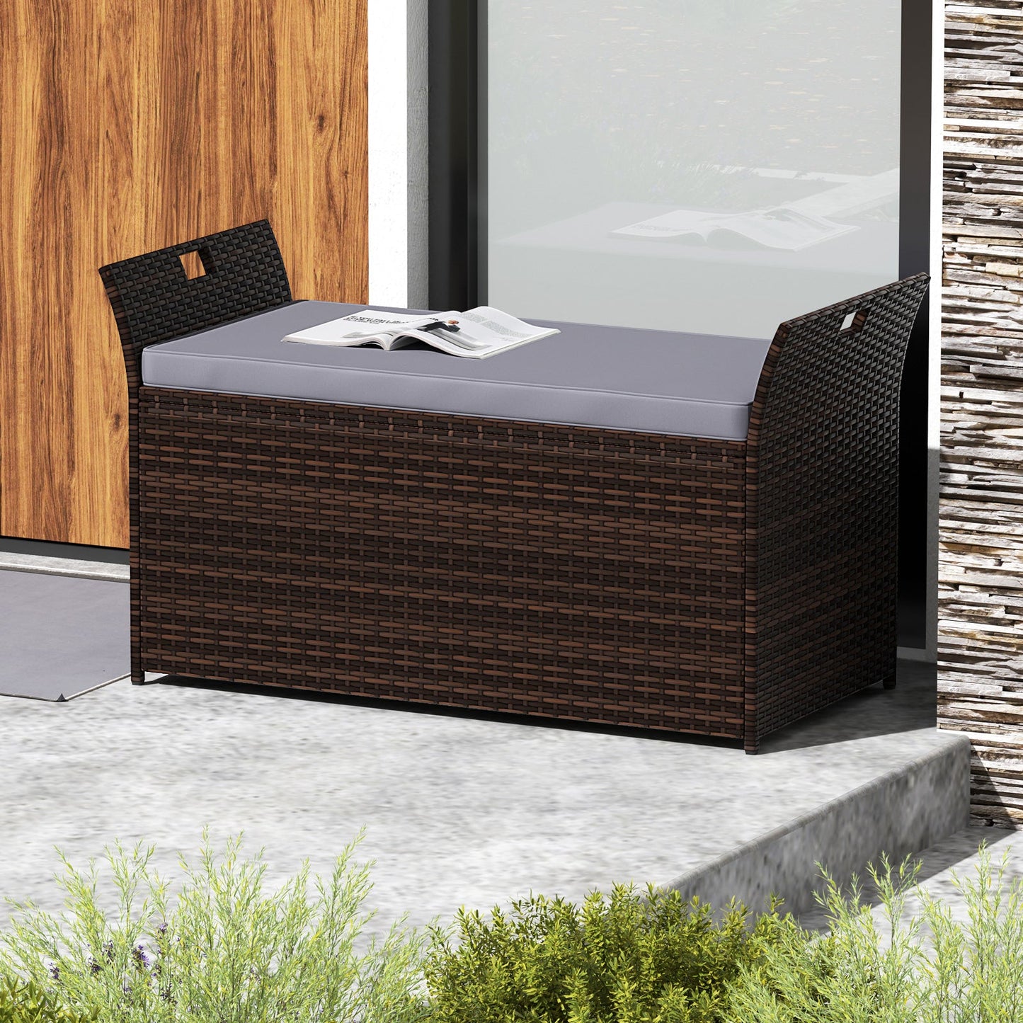 Outdoor Bench with Hand-woven PE Rattan Wicker and Side Handles-Gray in a garden setting, showing storage and comfortable cushion.