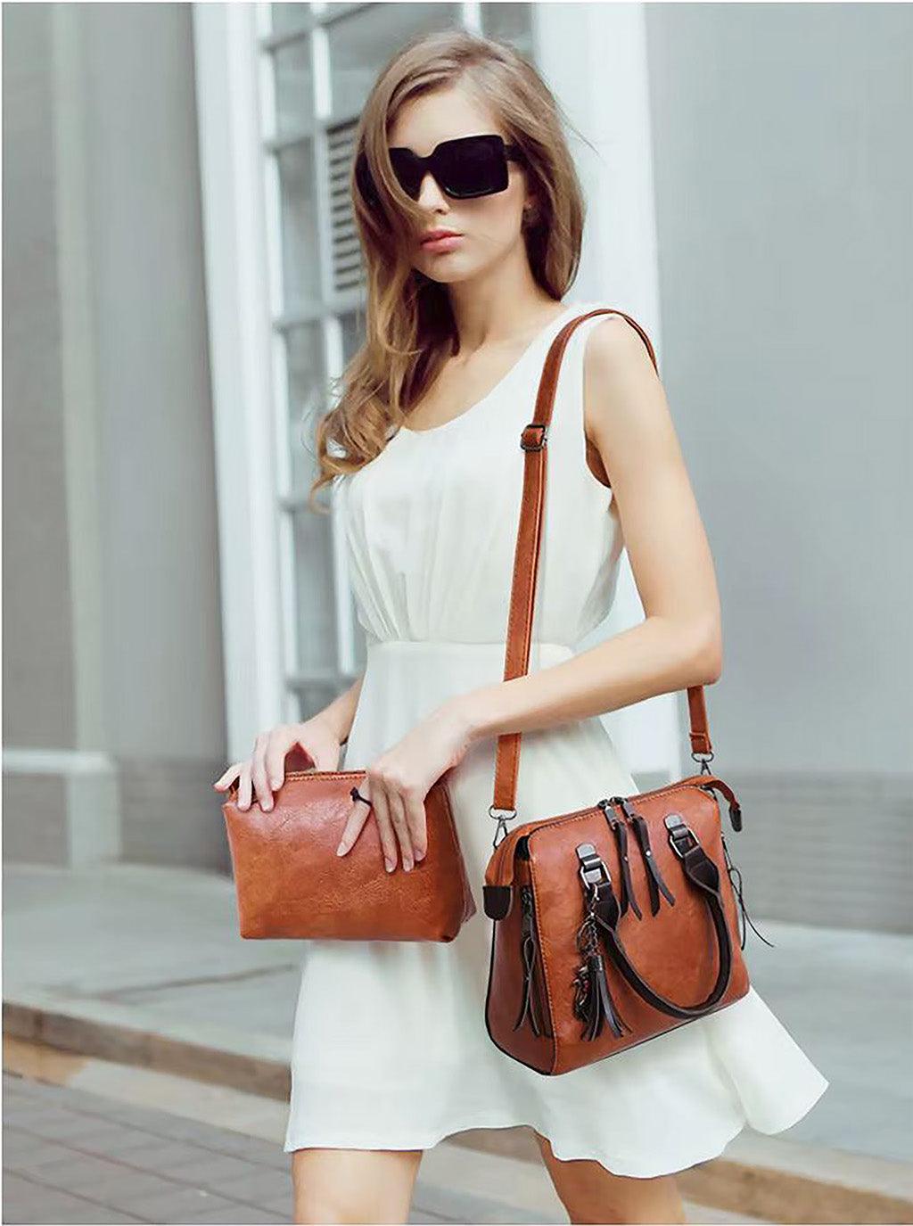 Woman carrying Vintage Leather 4-Piece Messenger Bag Set | Luxury Leather Tote, Clutch & Wallet Set in a stylish outfit on the street.