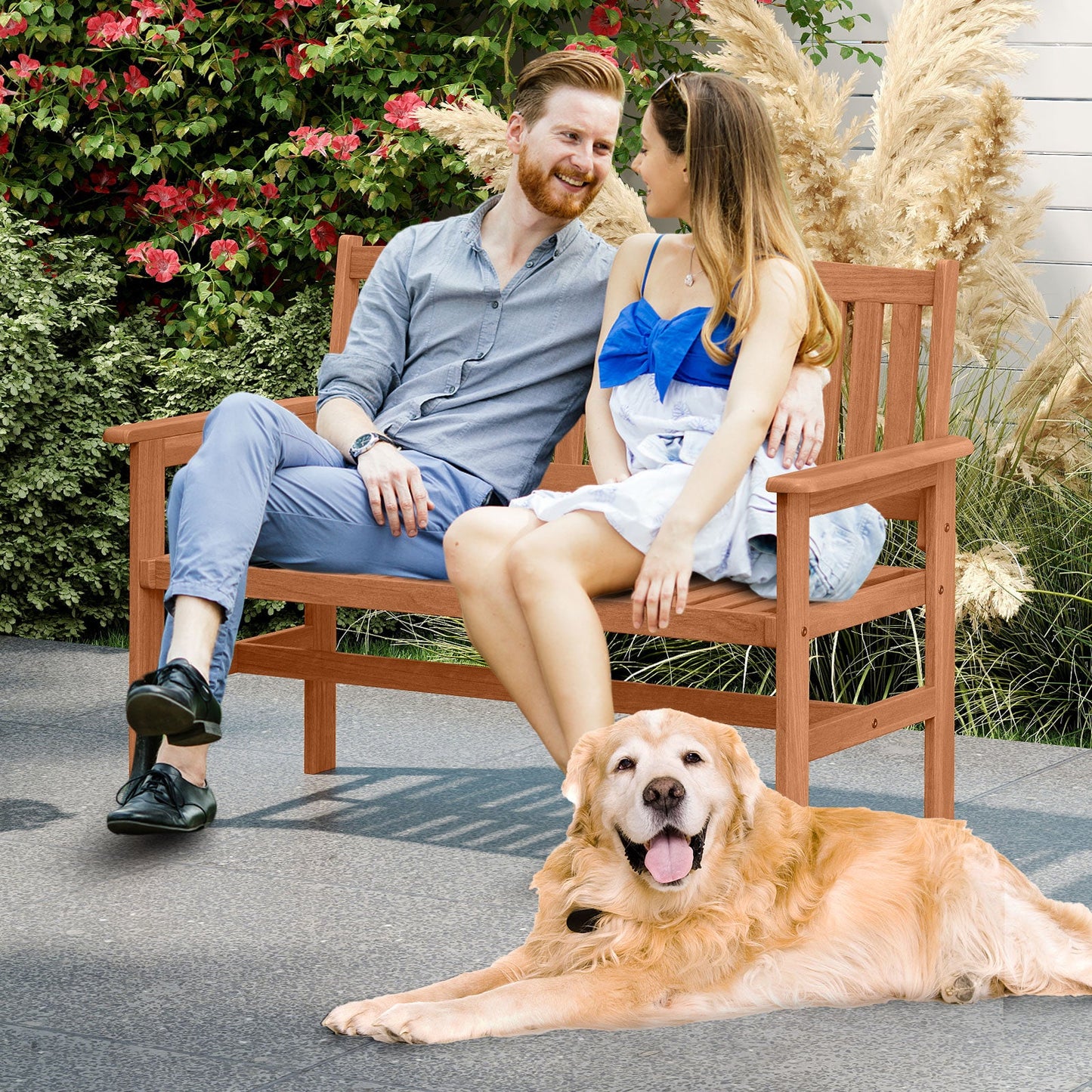 Couple enjoying a 2-Person Patio Loveseat with Slatted Backrest and Comfortable Armrests on a sunny day with a dog nearby.