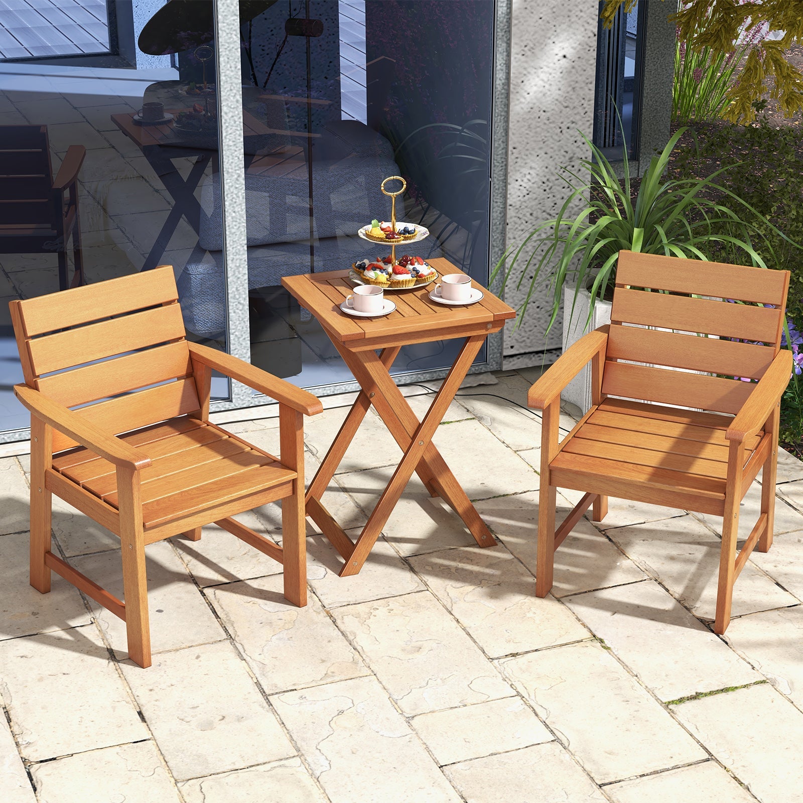 2 Piece Patio Hardwood Chair with Slatted Seat and Inclined Backrest set on a patio with a small side table holding tea and snacks