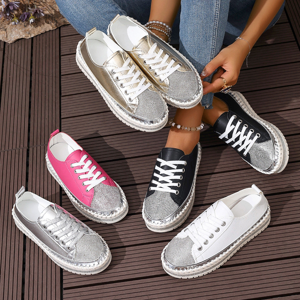 Various colorful sneakers displayed on a deck, featuring different styles and sparkling toe caps.