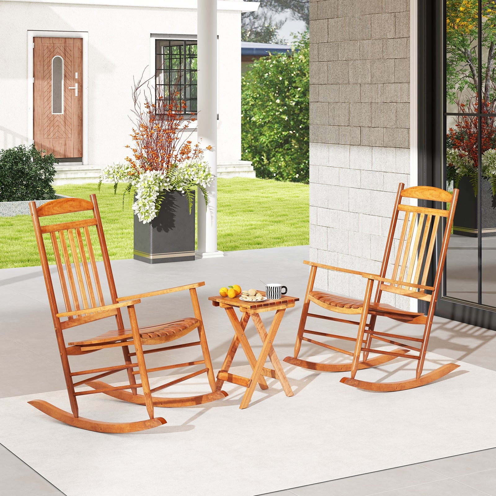 3-piece Outdoor Poplar Wood Rocking Bistro Set-Natural on a patio with folding table, perfect for relaxing with a stable and rustic design.