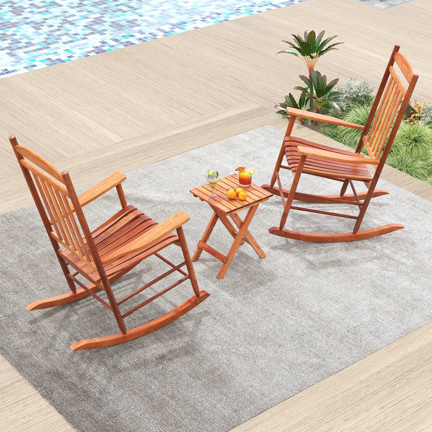 3-piece Outdoor Poplar Wood Rocking Bistro Set-Natural with two rocking chairs and folding side table on a rug by a poolside