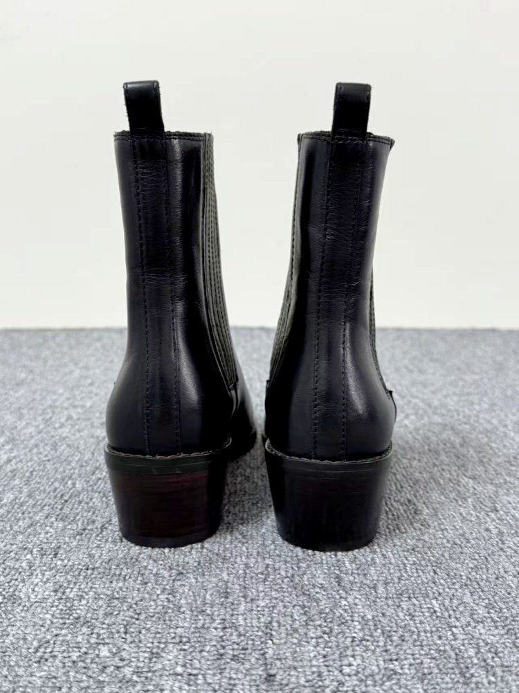 Back view of Women’s Retro Square-Toe Mid-Heel Chunky Leather Boots on gray surface.