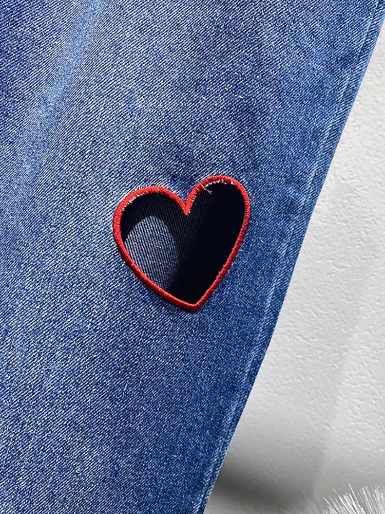 Heart Cutout Wide Leg Jeans | Romantic Wear for Women - Close-up of embroidered heart-shaped cutout on denim fabric