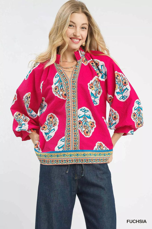 Woman wearing Umgee Boho Floral Print Tunic Blouse with vibrant floral design and split V-neck, ideal for casual and layering styles.