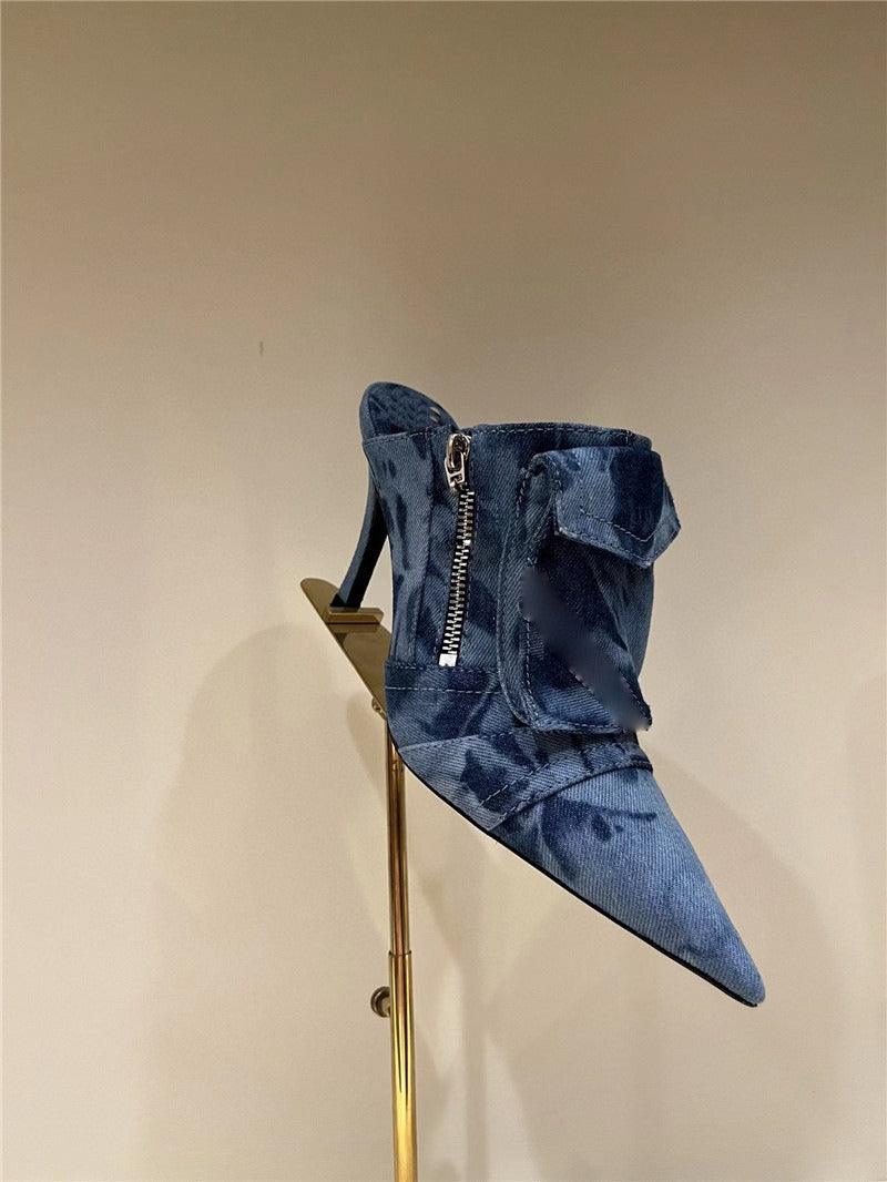 Women Pocket Denim Pointed Toe Heeled Ankle Boots with high heel and zipper design on display stand.